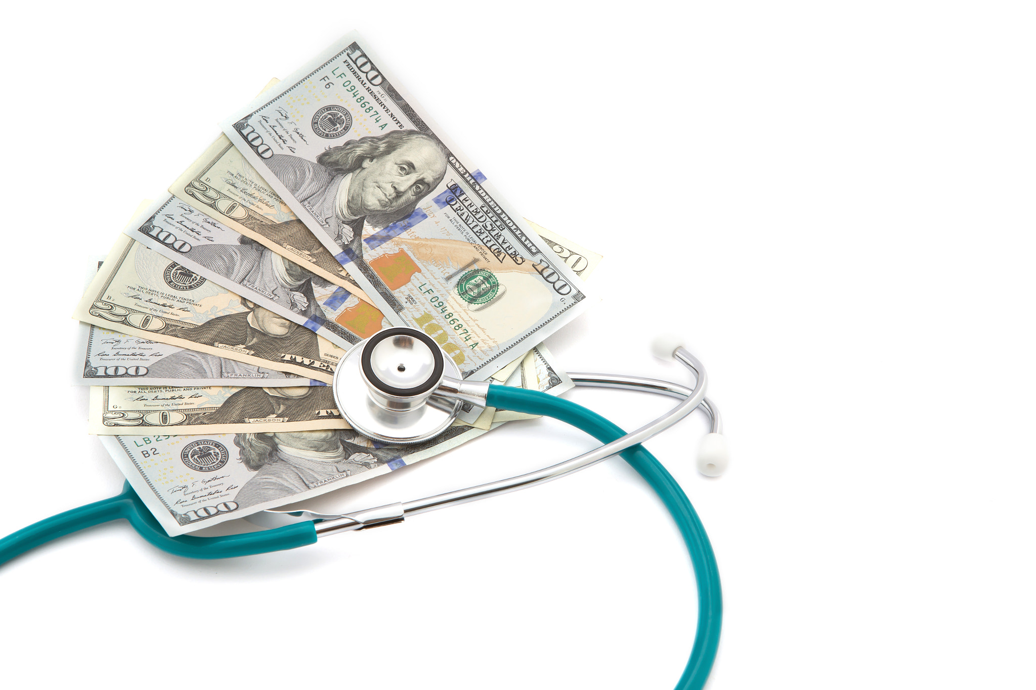 Stack of coins and money and stethoscope