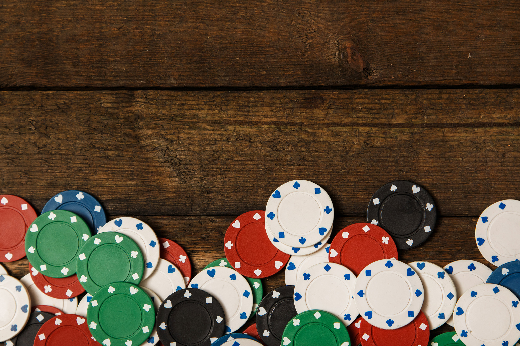 Poker chips over wooden background