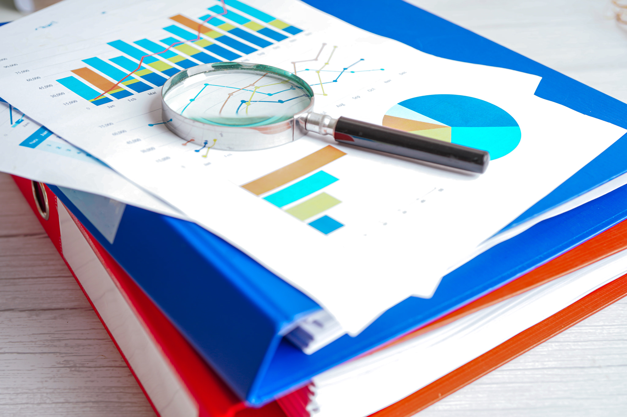 Magnifying glass on charts graphs paper. Financial development, Banking Account, Statistics, Investm
