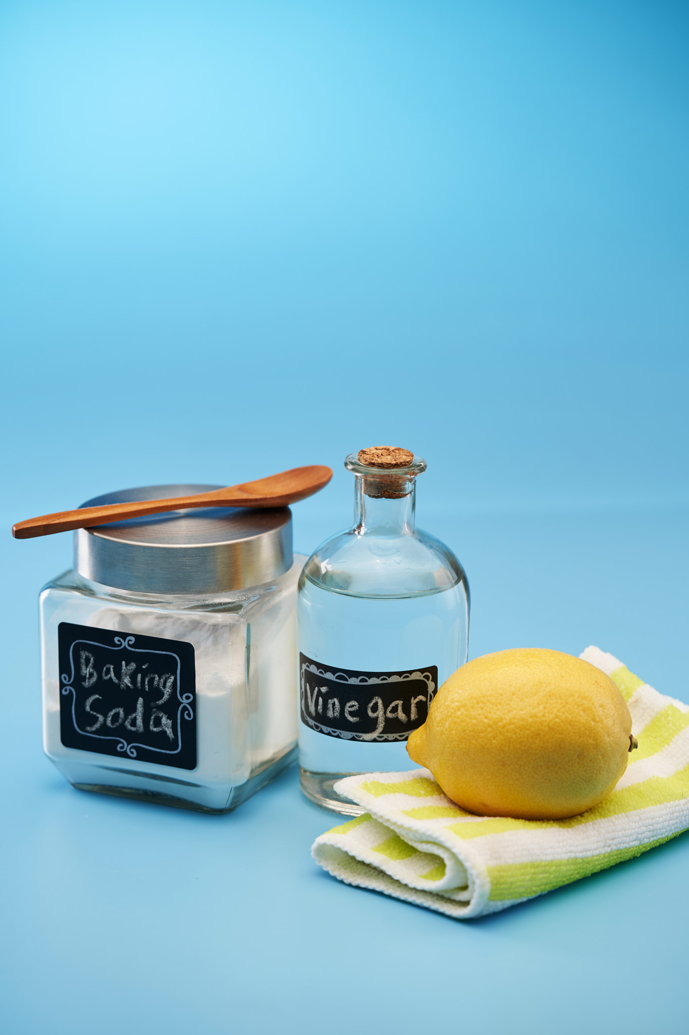 baking soda lemon and vinegar against blue background
