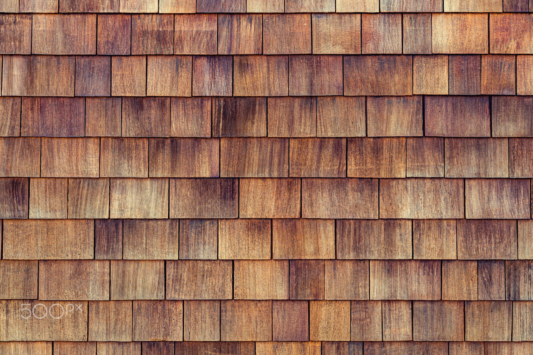 Grunge cedar tile panel on the exterior wall