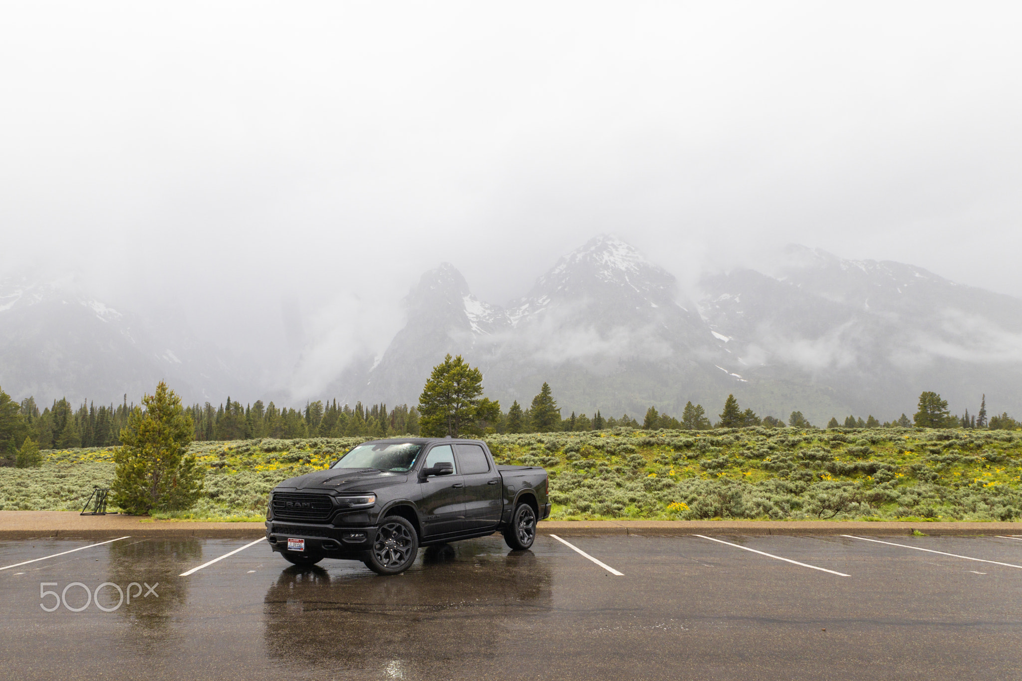 Car  with foggy mountains in Grand Tetons National park