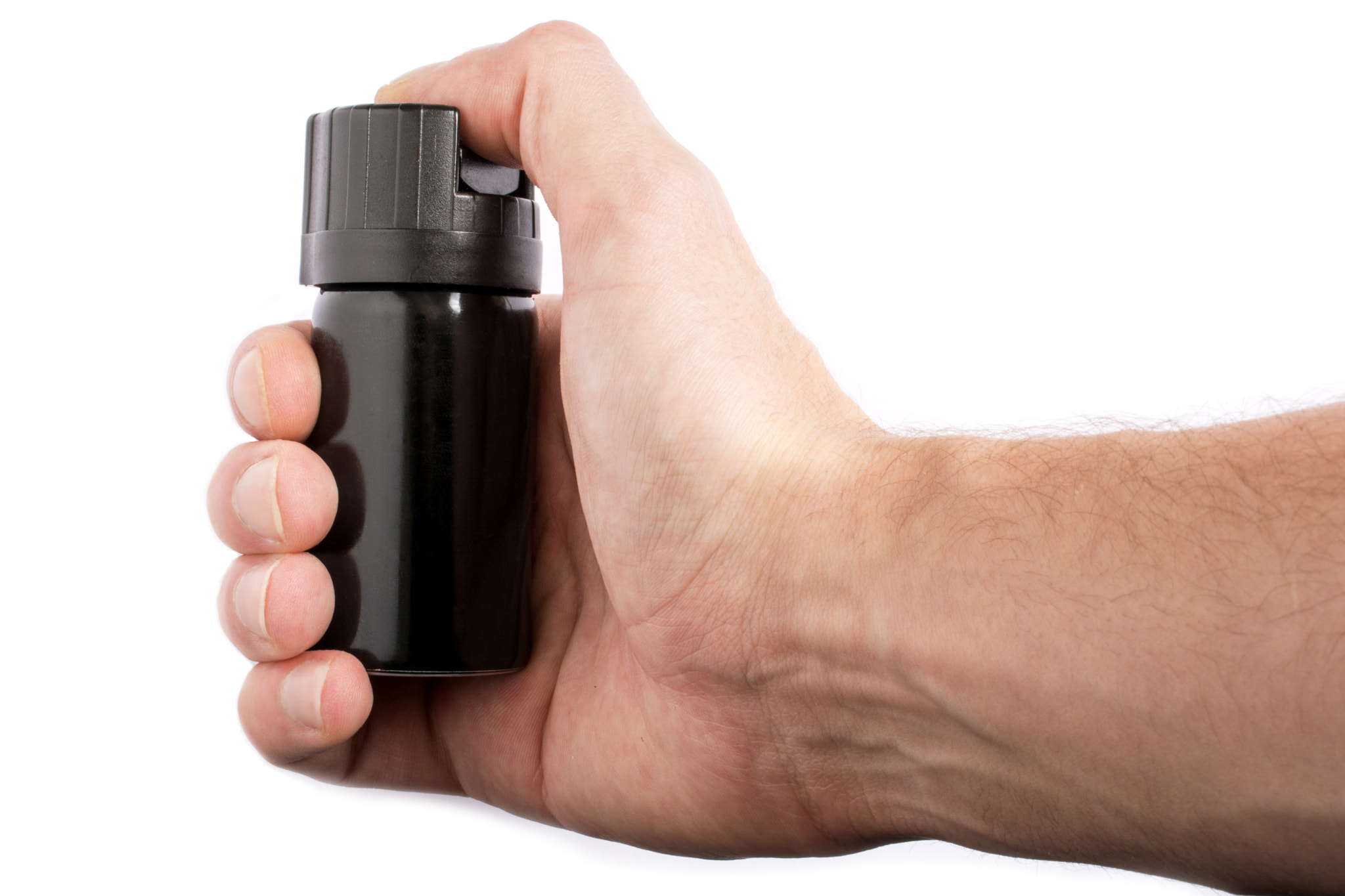 Hand with bottle of pepper spray isolated on white background