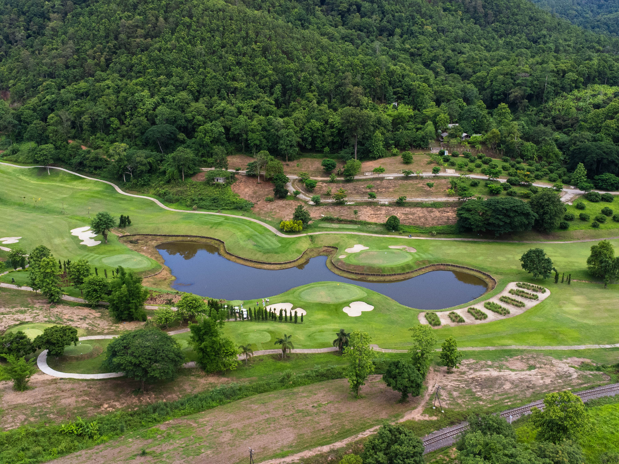 Aerial view of golf course with a rich green turf beautiful scenery. Sand bunkers at a beautiful gol