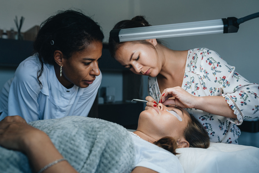 beautician teaches a student how to do eyelash lamination by Natalie Zotova on 500px.com