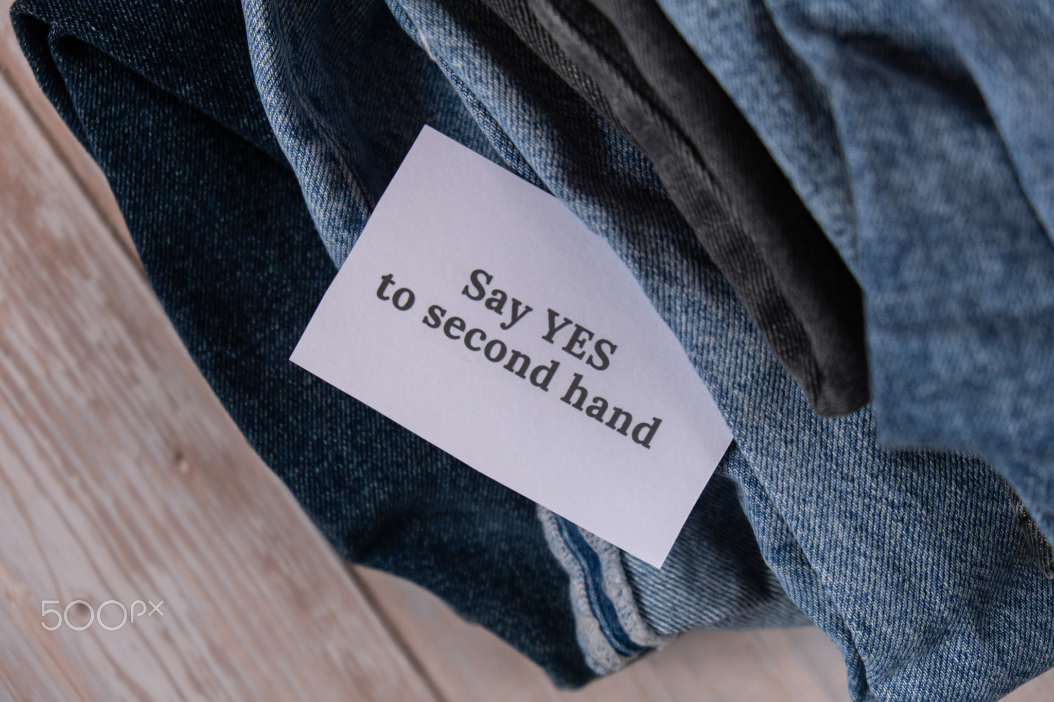 SAY YES TO SECOND HAND text on paper note on Jeans clothes assortment