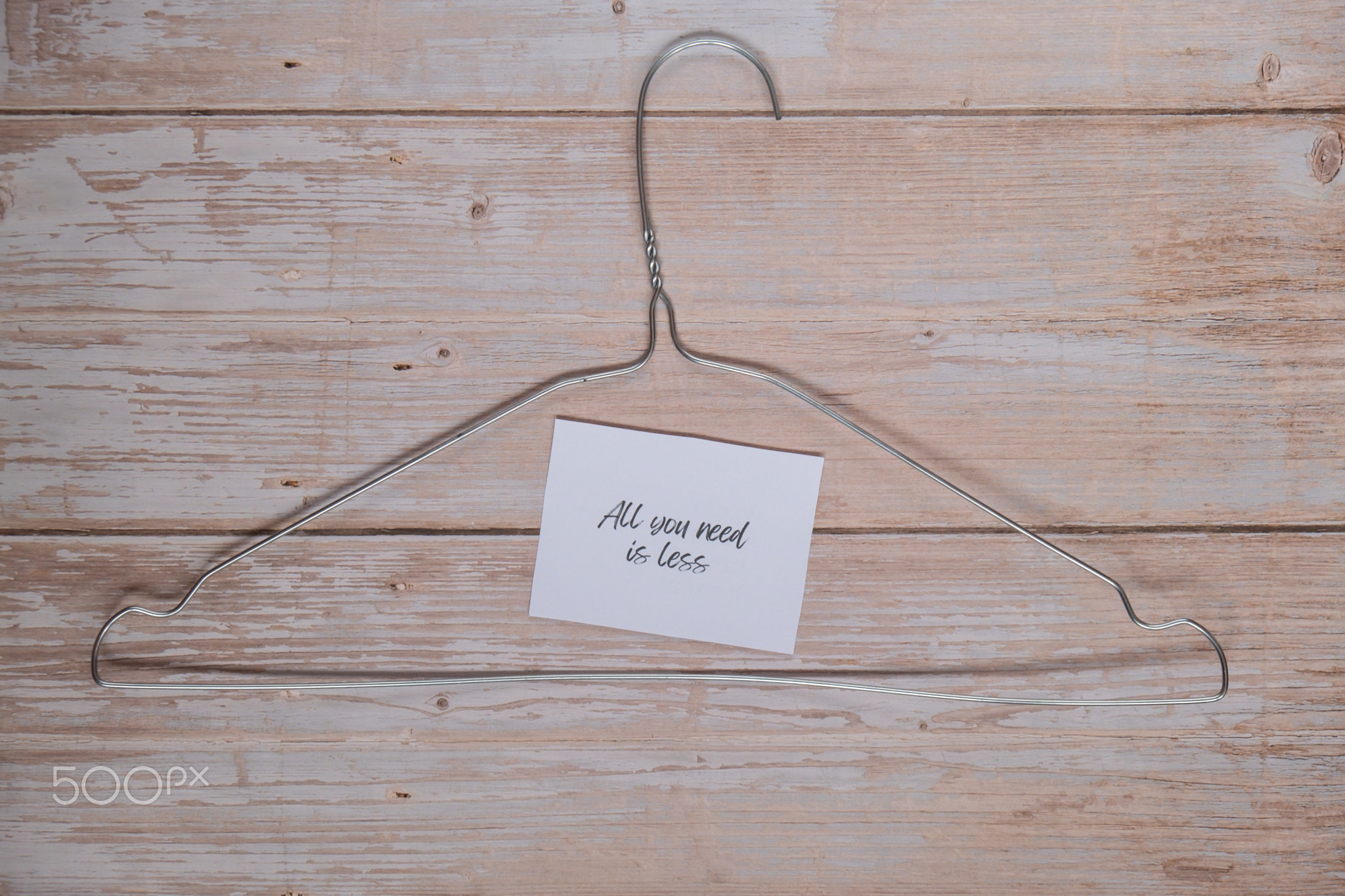 ALL YOU NEED IS LESS text with clothes rack. Second hand sustainable
