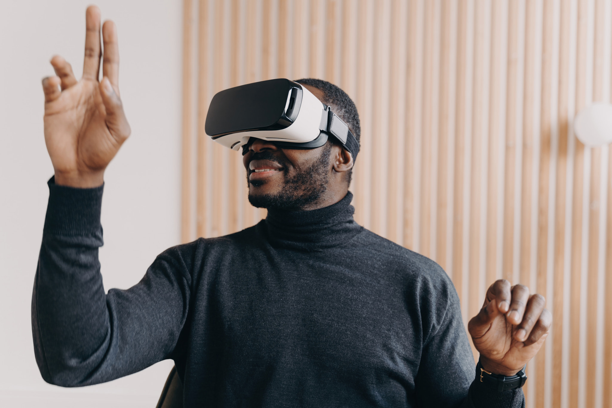 Smiling African American businessman in VR glasses, office setting, testing virtual reality goggles,