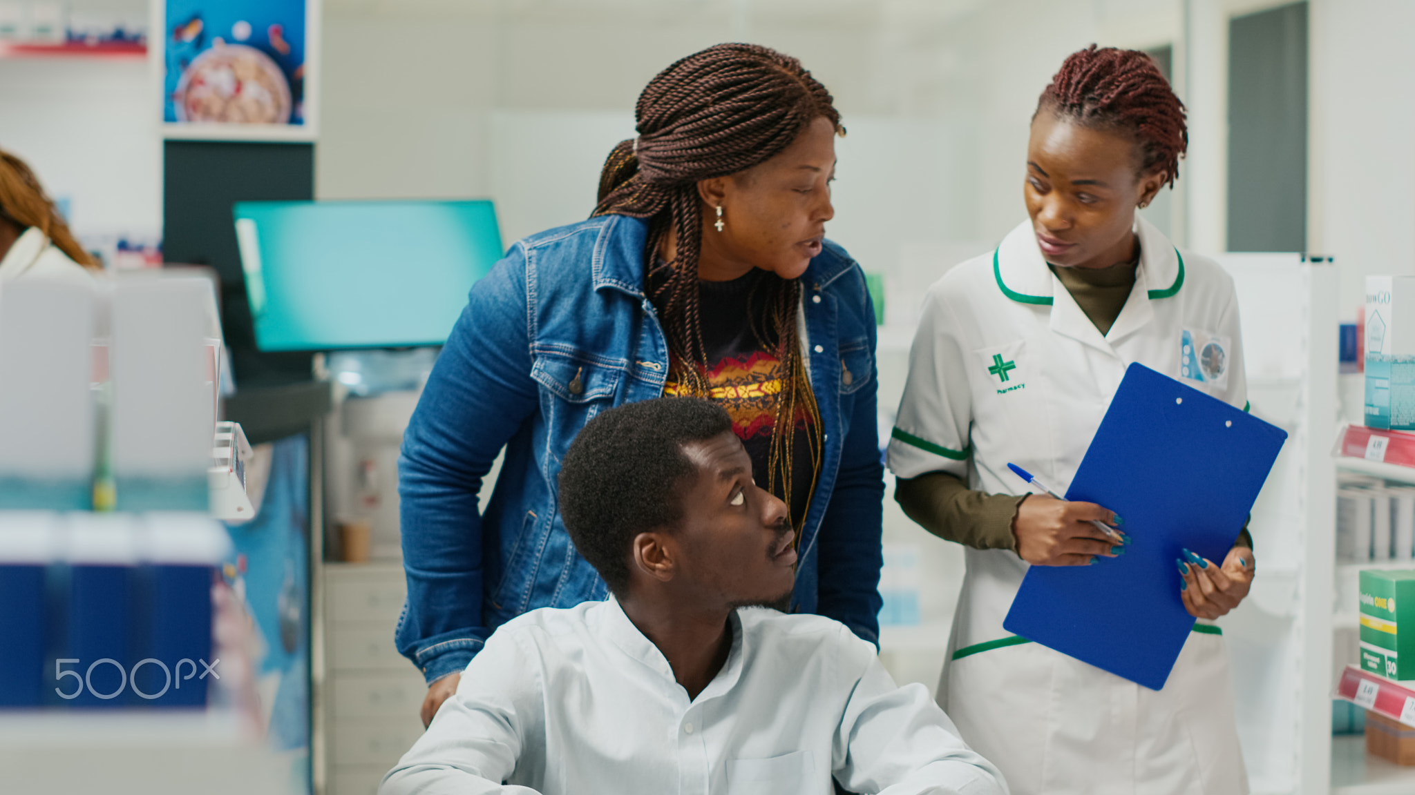 Pharmacy assistant helping woman with impairment