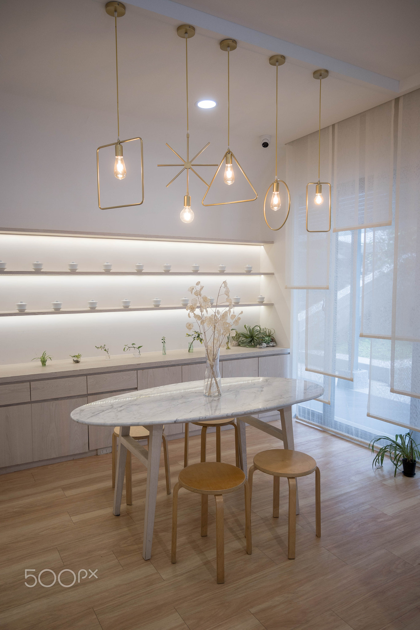 Minimal interior dining room with marble table and a white base tone