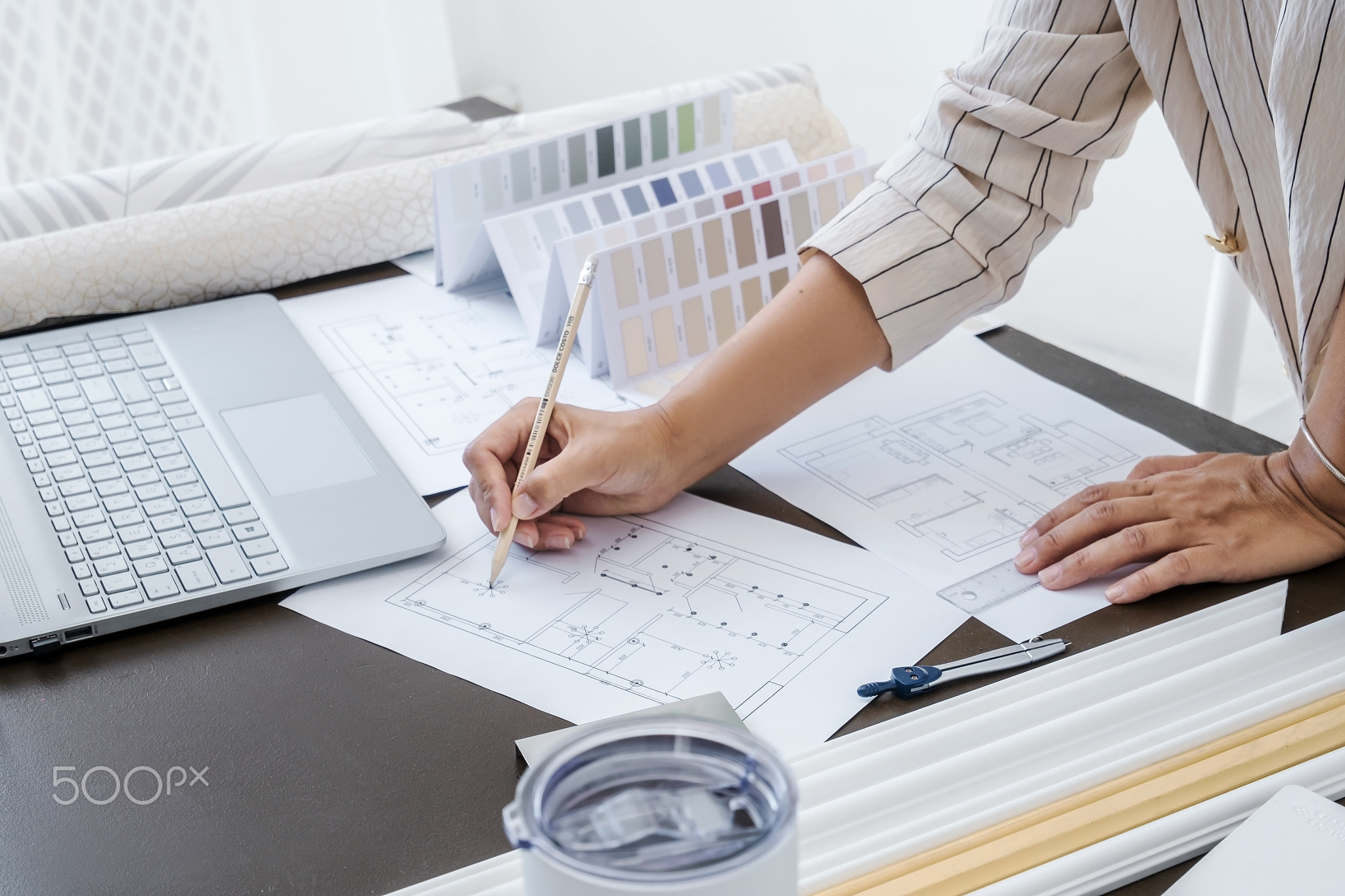 Side view of interior designer or architect in casual wear working on