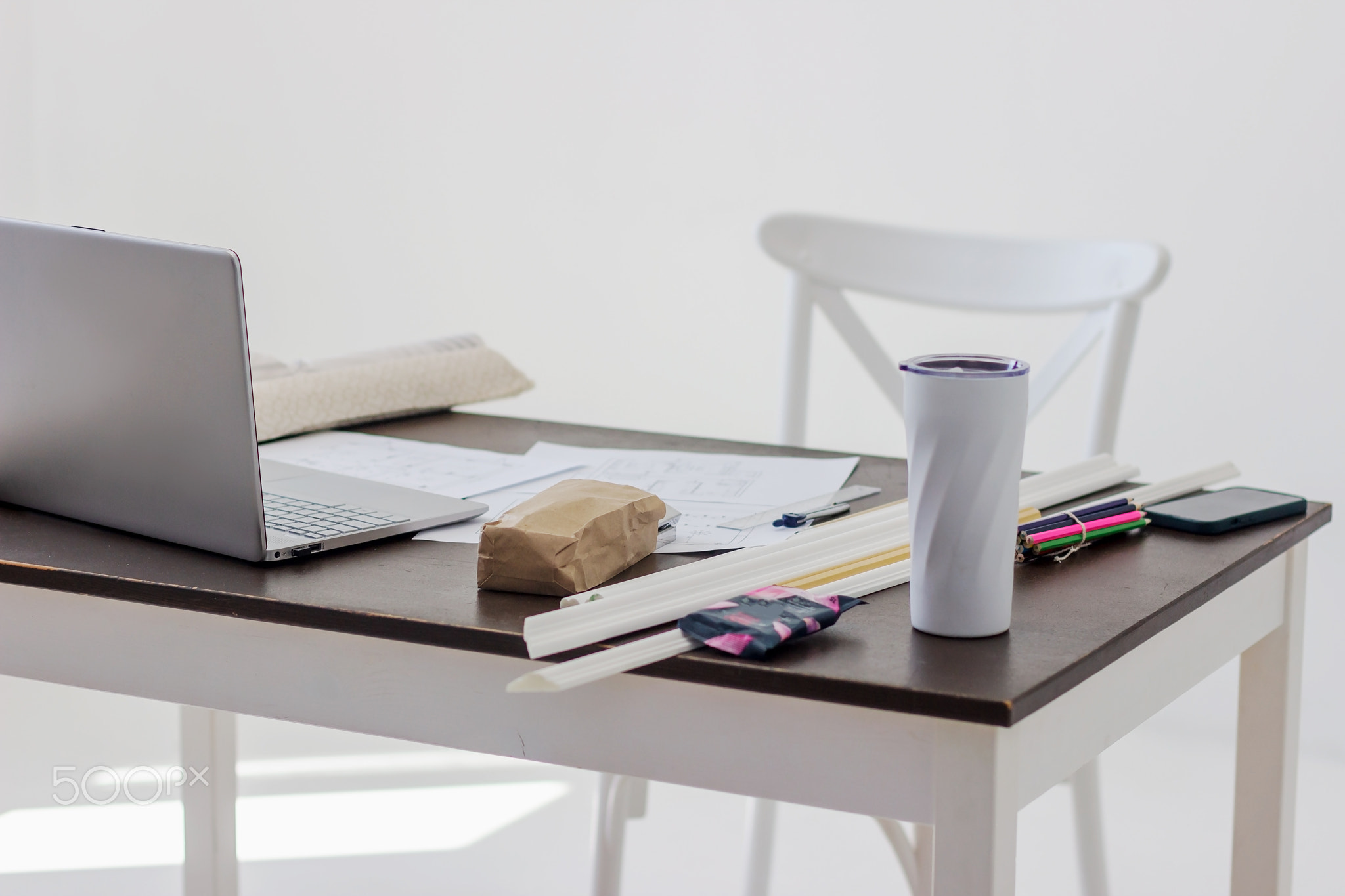 Side view of interior designer or architect workplace with a blueprint