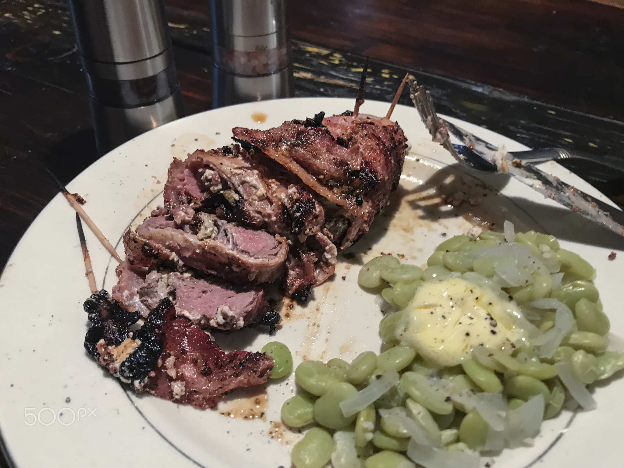 Pork loin dinner with lima beans and butter.