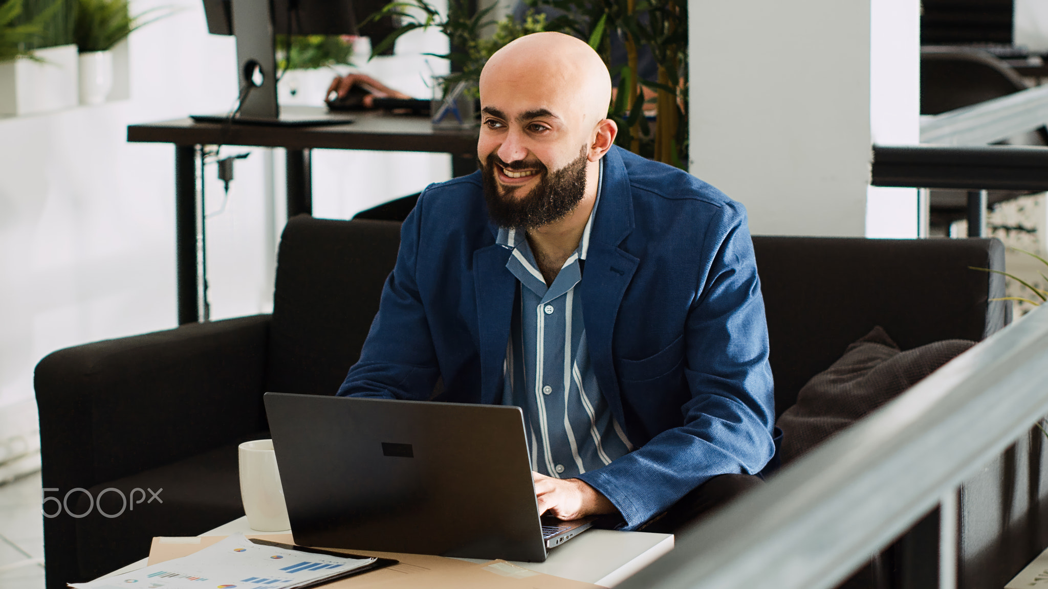 Startup employee works on laptop