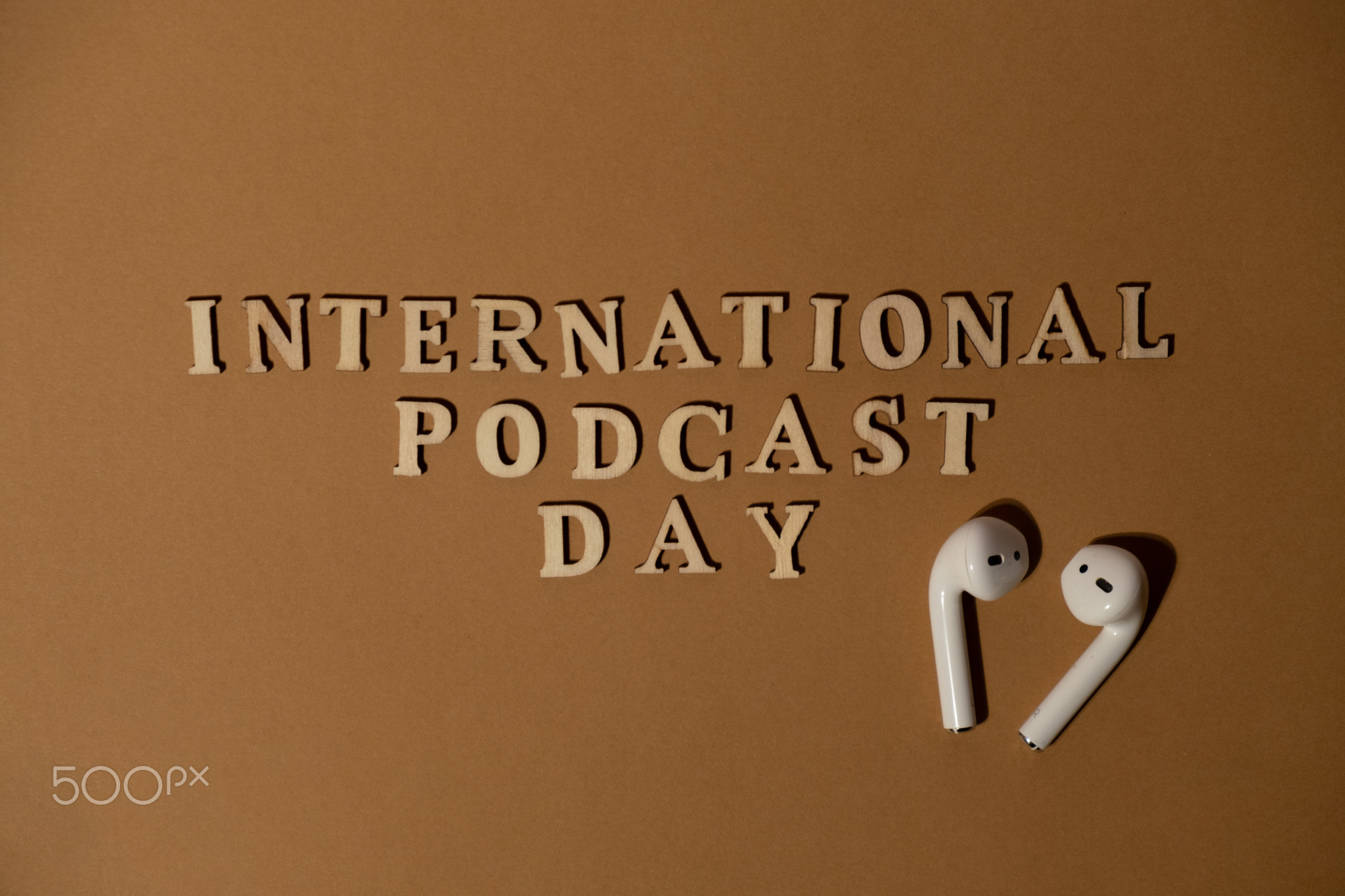 Announcement text INTERNATIONAL PODCAST DAY on beige background with