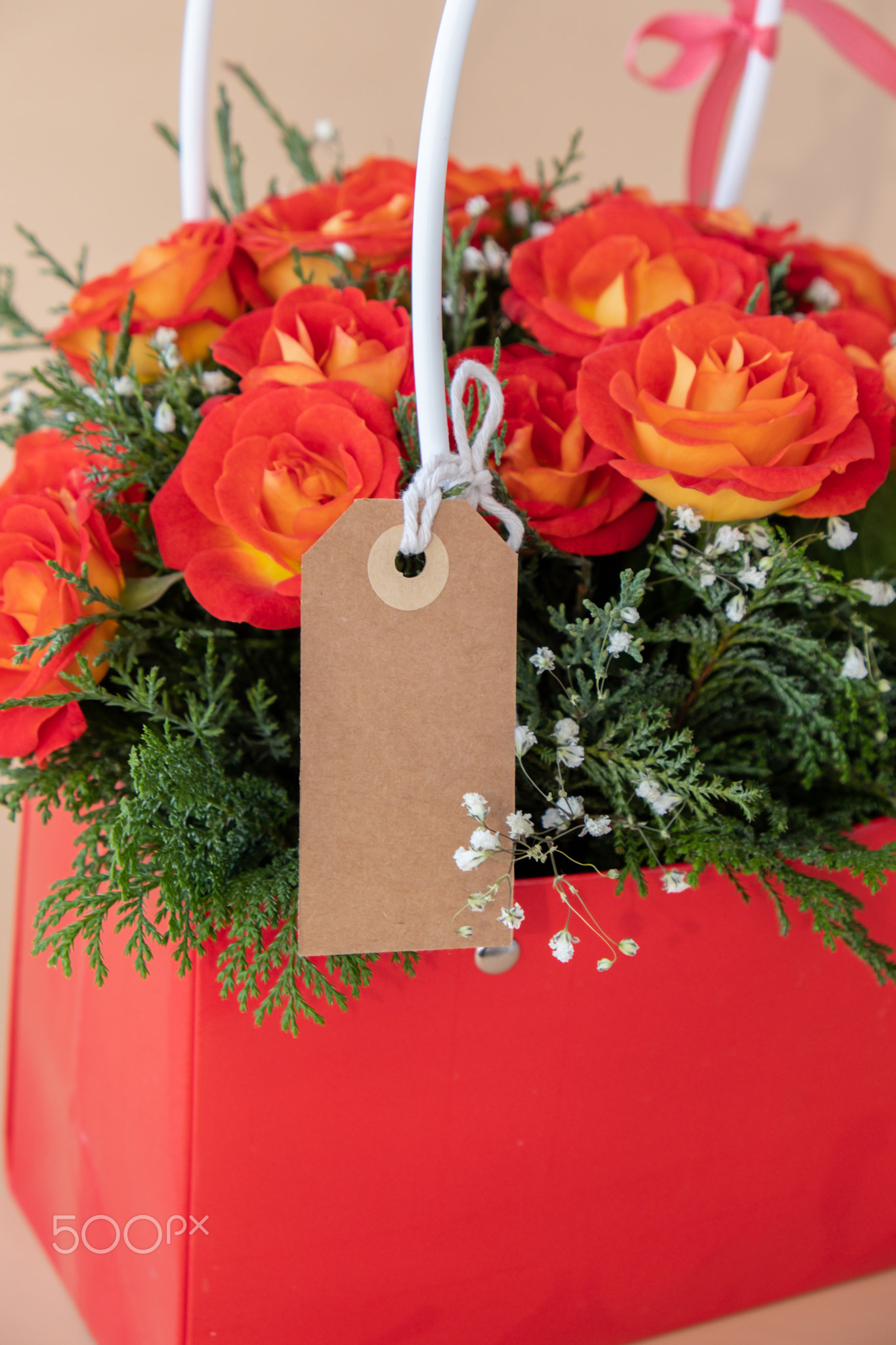 Bouquet of red roses with empty paper note copy space decorated in hat