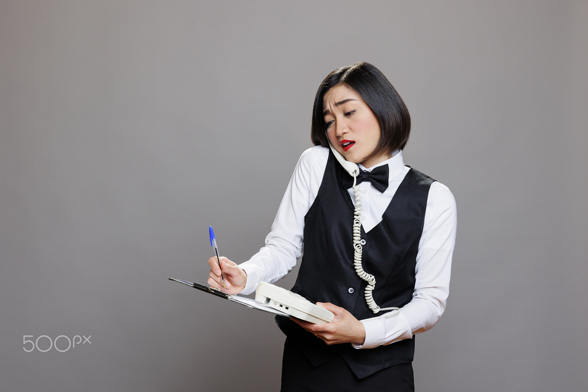 Receptionist with clipboard talking