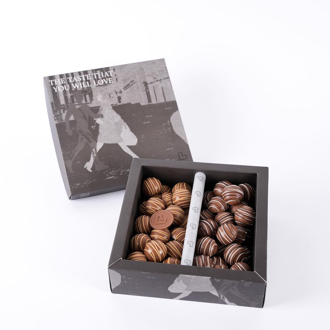 Close-up of chocolates in box against white background