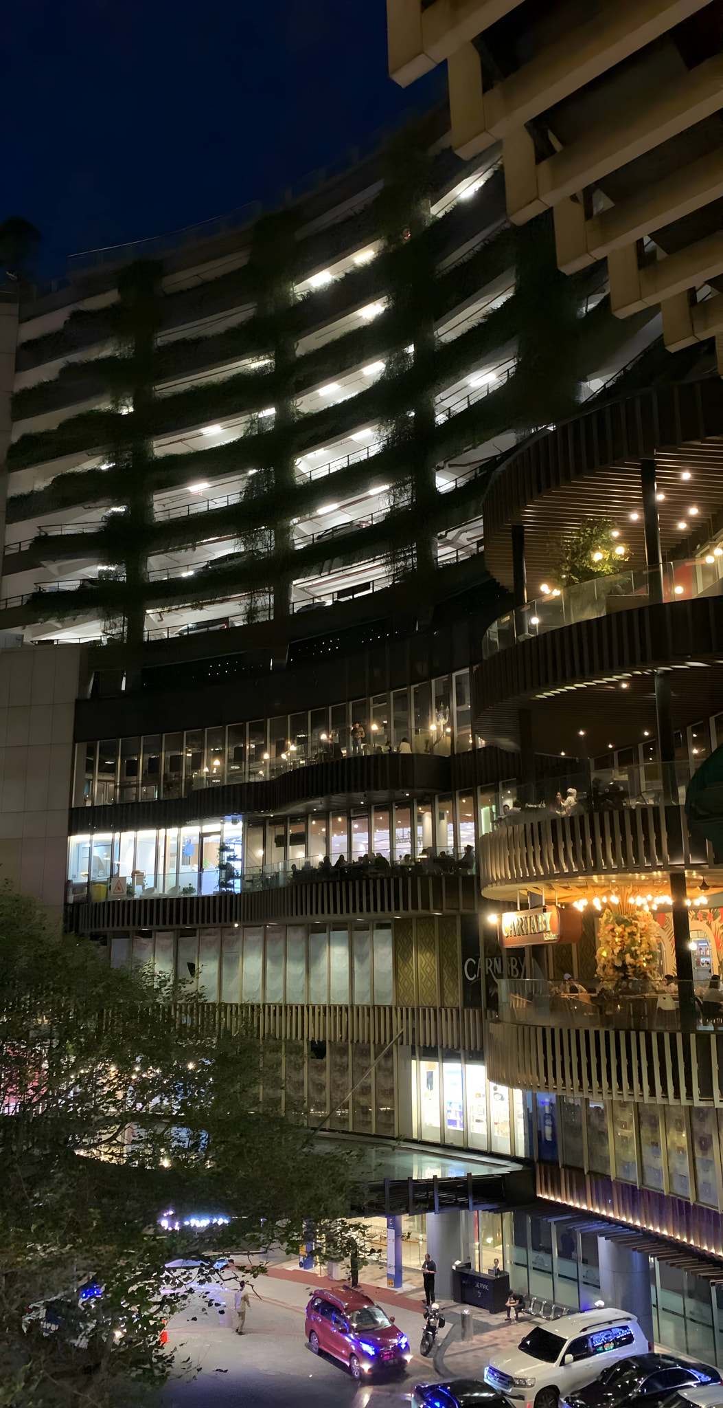 Modern skyscrapers illuminate the night cityscape