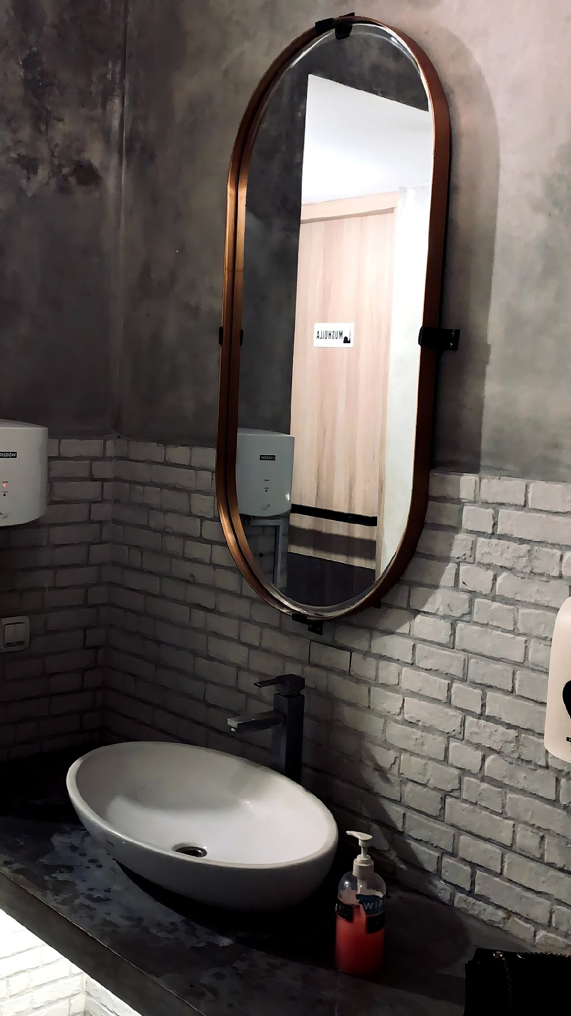 Clean and modern bathroom with vanity, mirror, and sink.