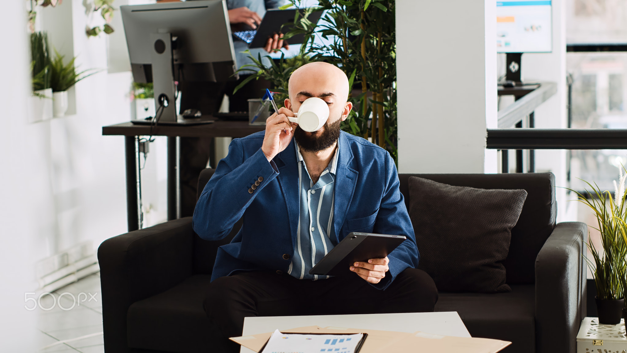 Middle eastern man takes notes on tablet