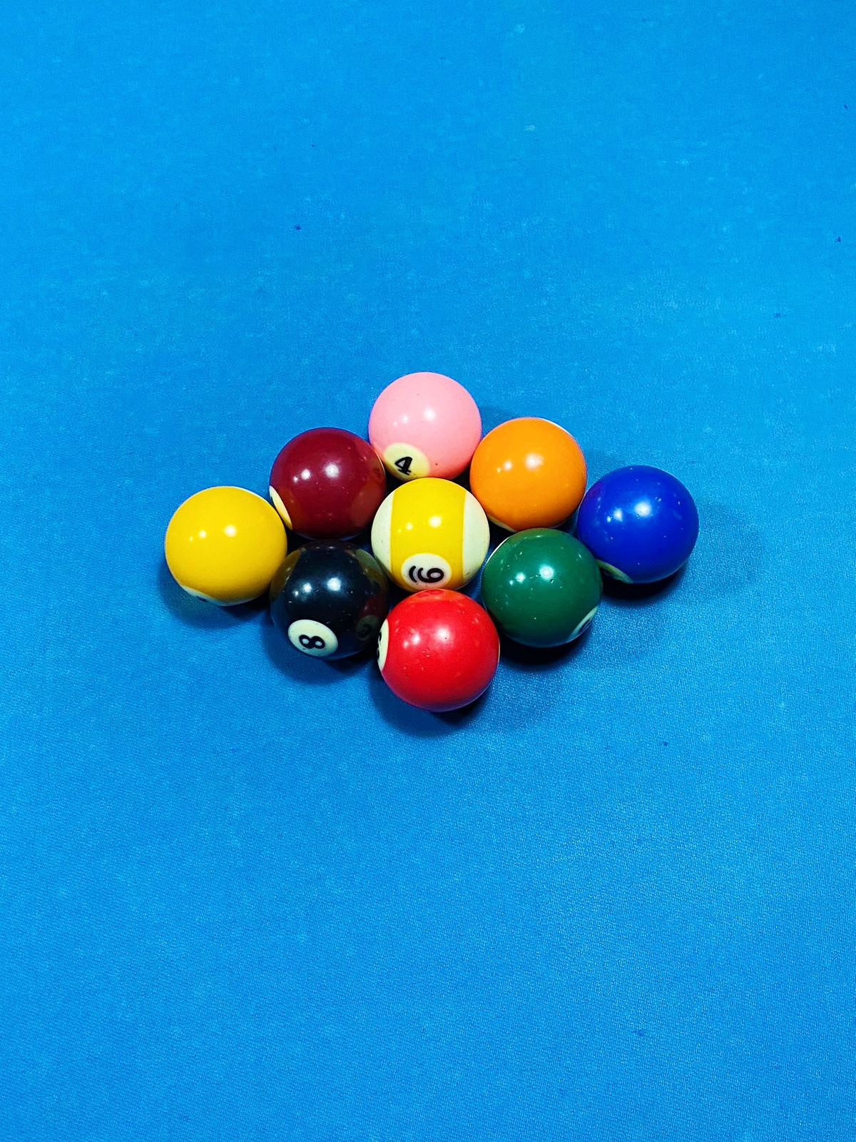 High angle view of multi colored balls on pool table