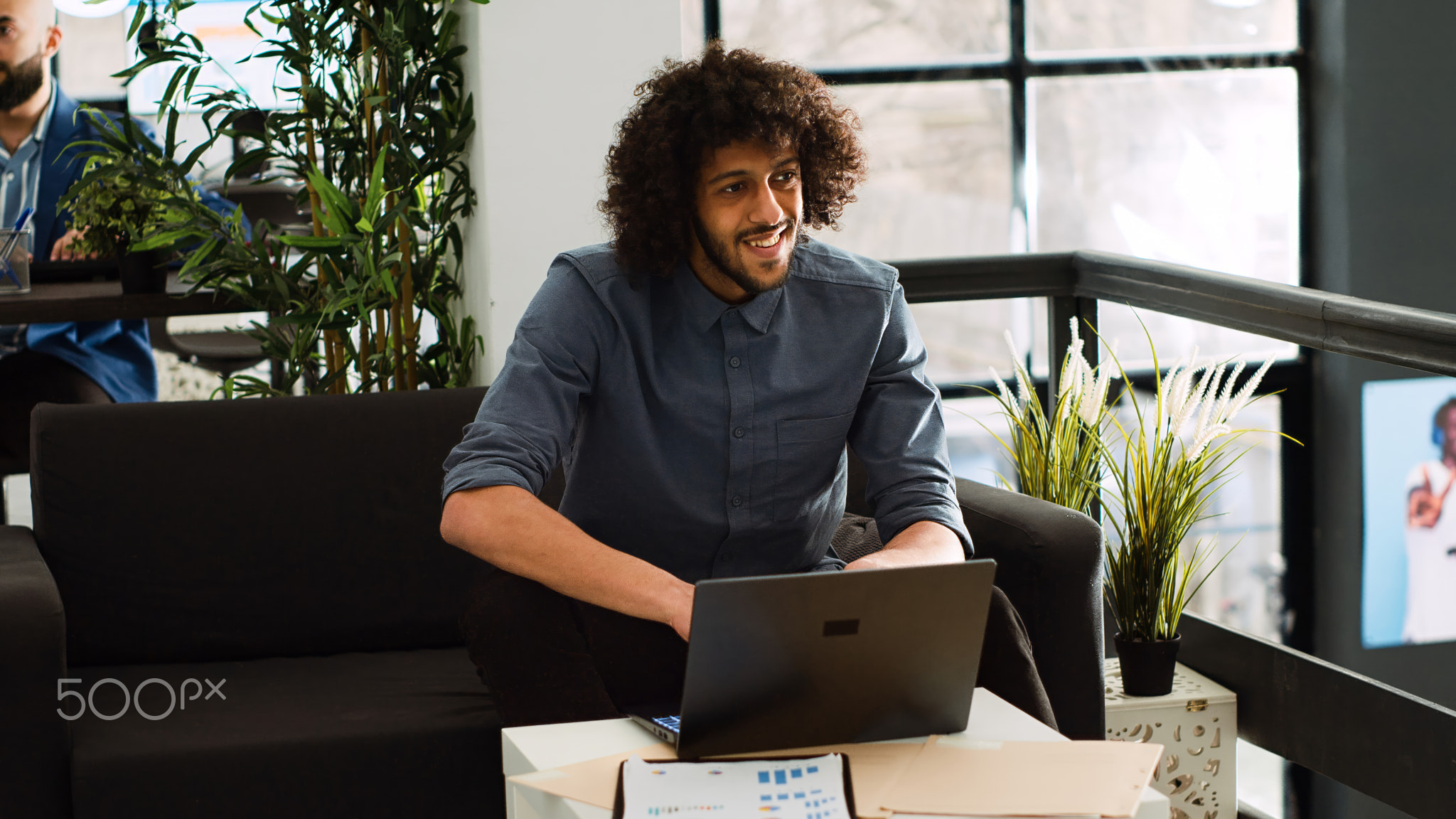 Businessman creating report on laptop