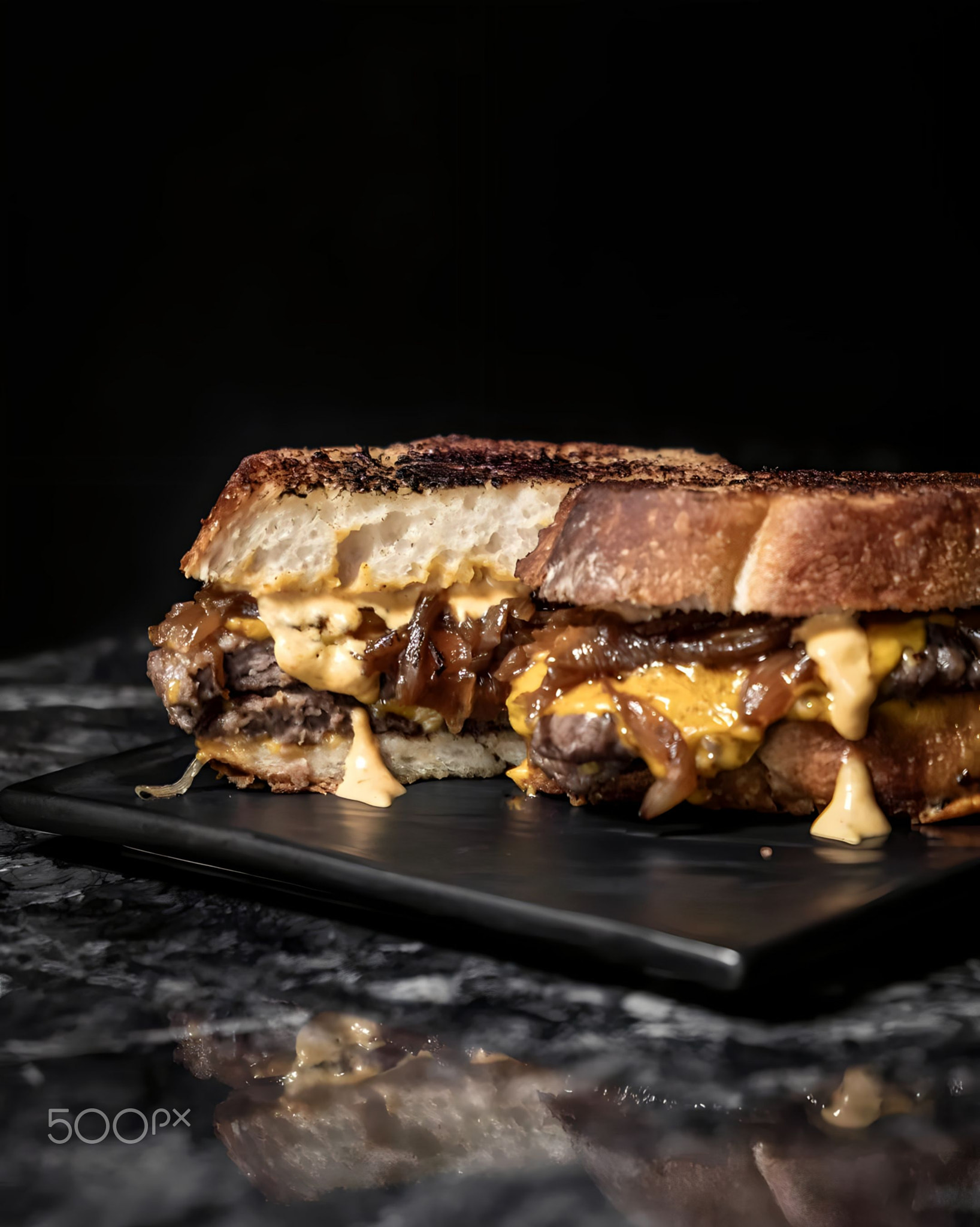 Close-up of brown toast in plate on table against black background