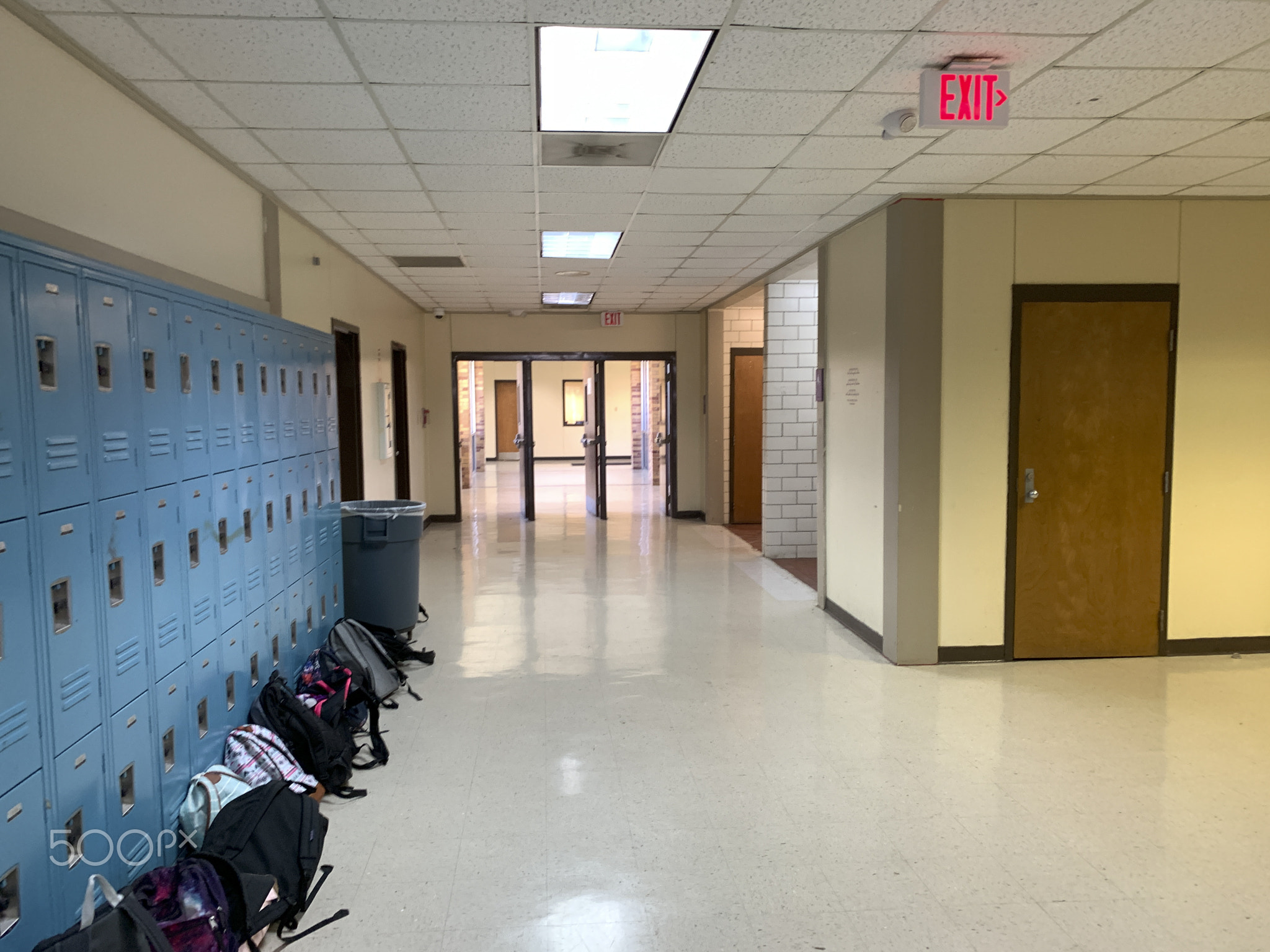 Interior of a high school with backpacks.