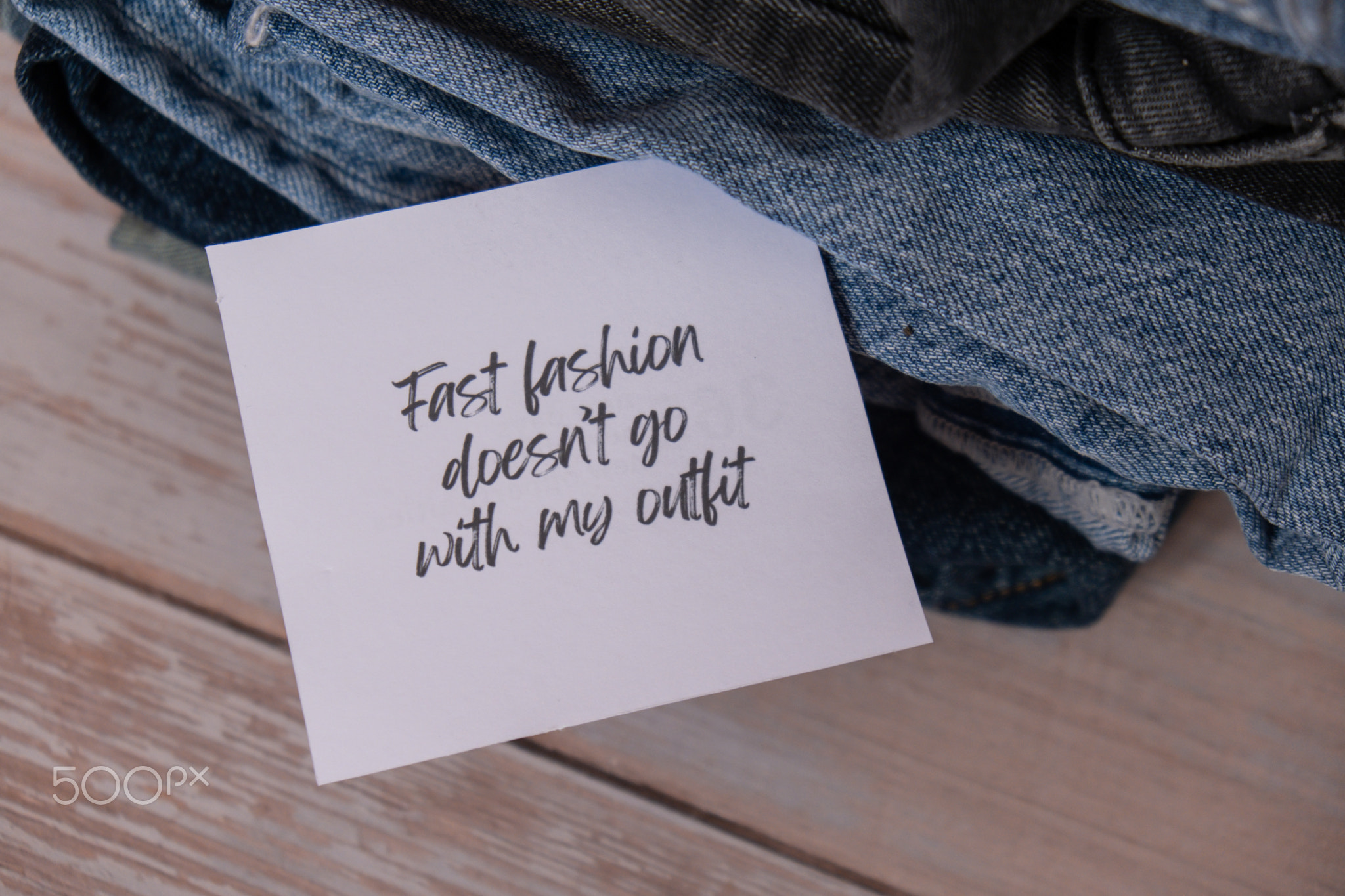FAST FASHION DOESNT GO WITH MY OUTFIT text on paper note on Jeans