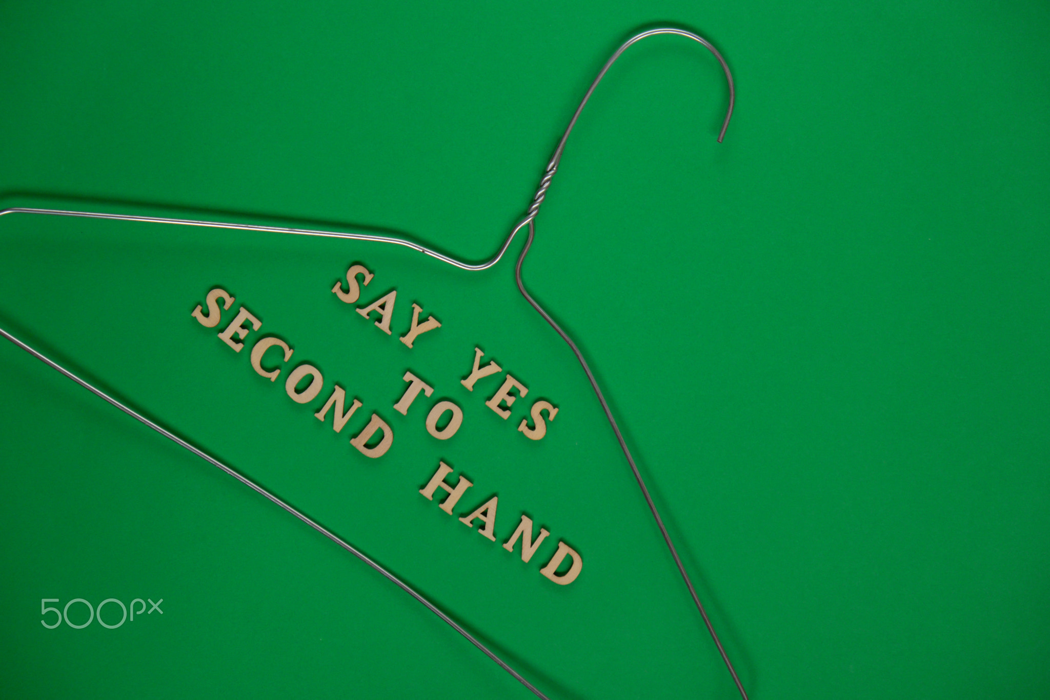 SAY YES TO SECOND HAND text with clothes rack. Second hand sustainable