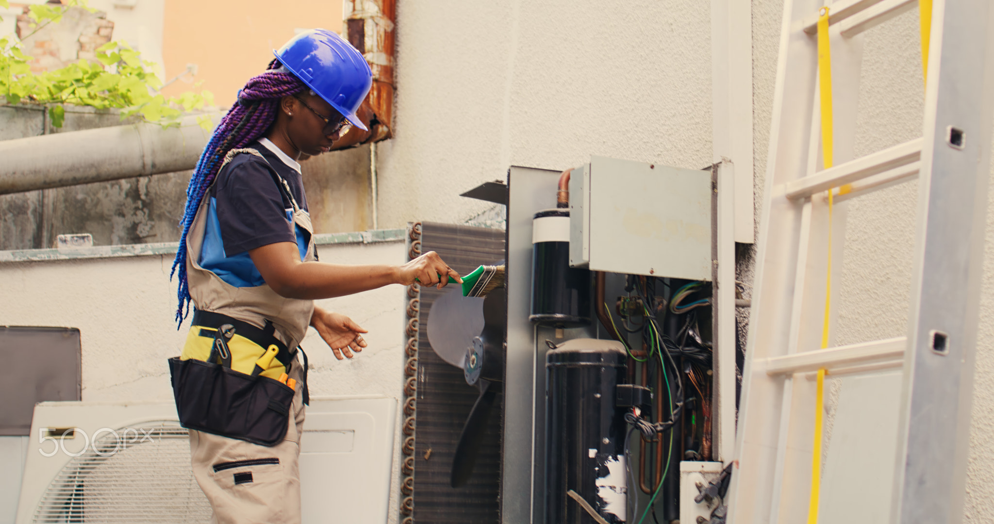 Electrician doing condenser maintenance