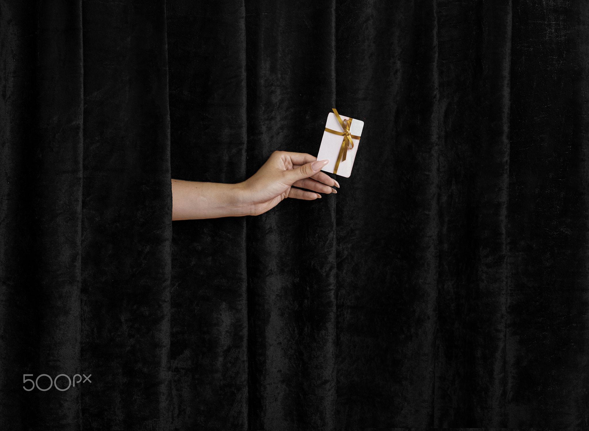 Golden Ticket to Discounts: A Hand Extends the Joy of Black Friday Shopping