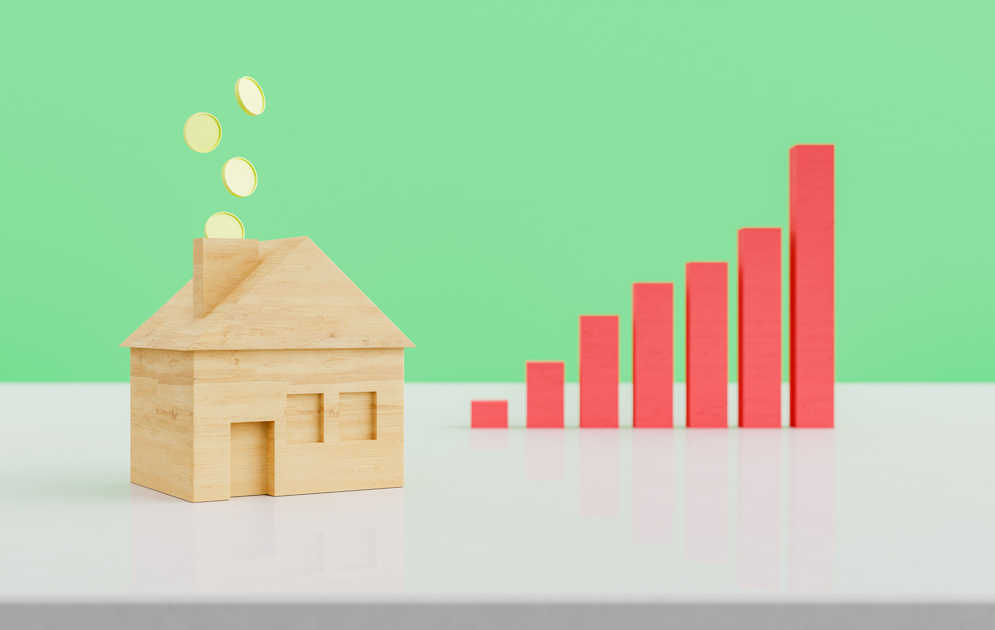 Wooden house miniature with coins and graph against green background