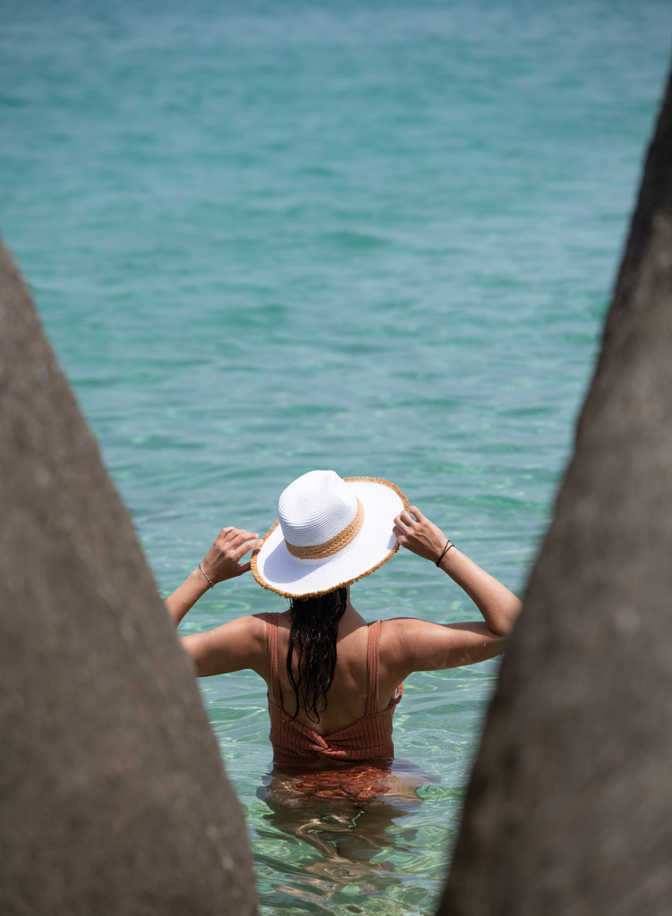 Rear view of young woman wearing hat while standing by sea by Ksenia Amosova on 500px.com