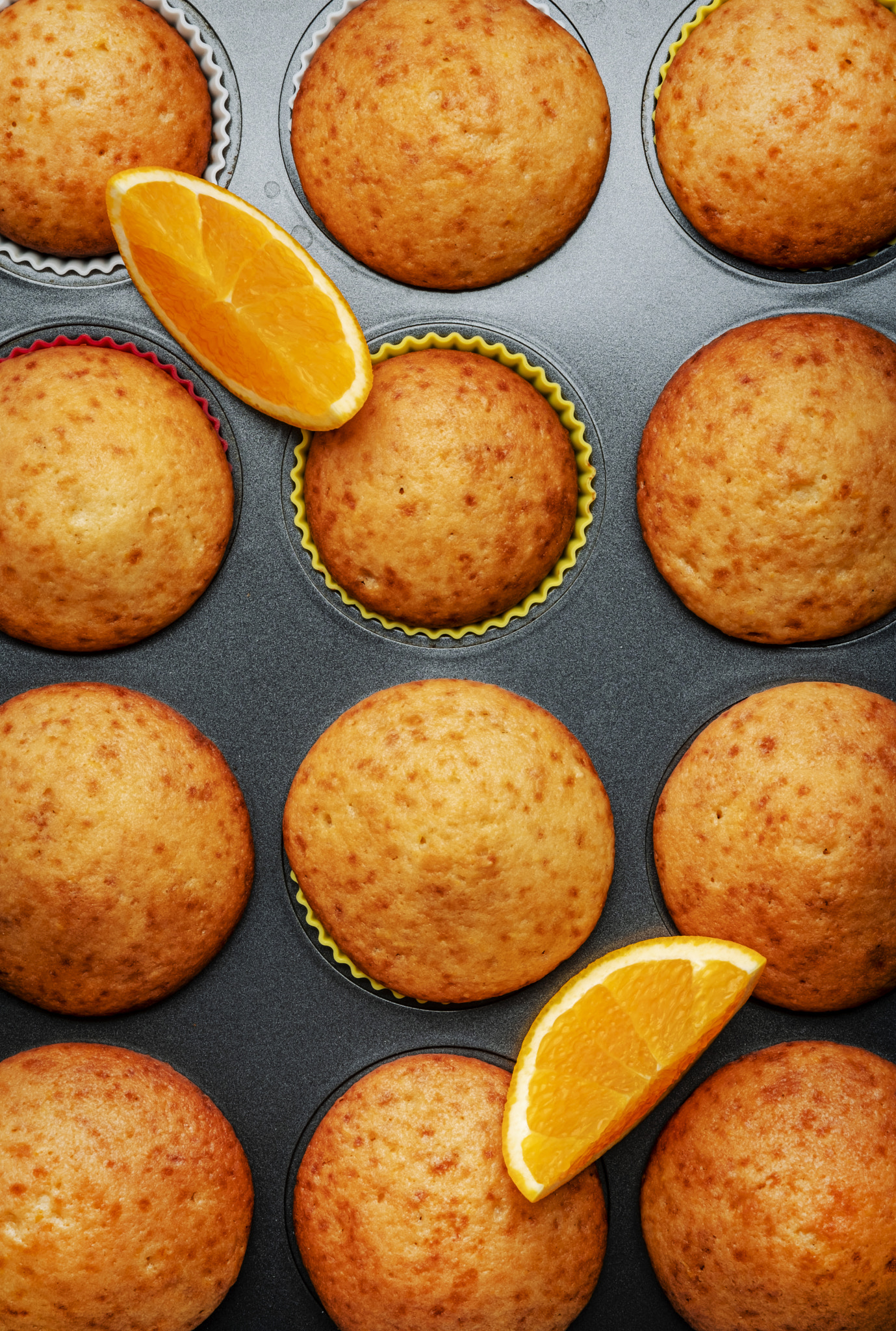 Appetizing orange muffins or cupcakes in a baking dish, winter homemade pastries, top view