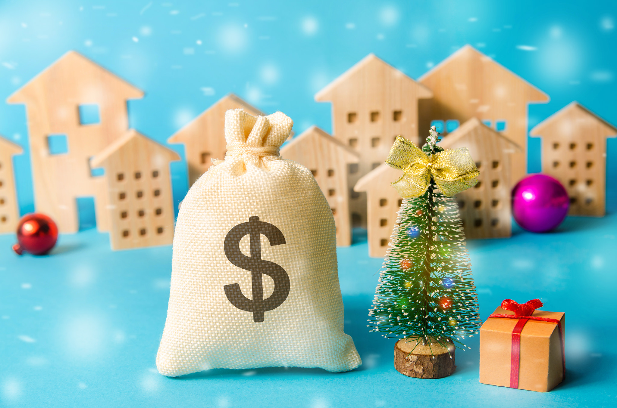 Dollar money bag, Christmas tree and miniature houses. Accumulating money and planning a budget. Bus