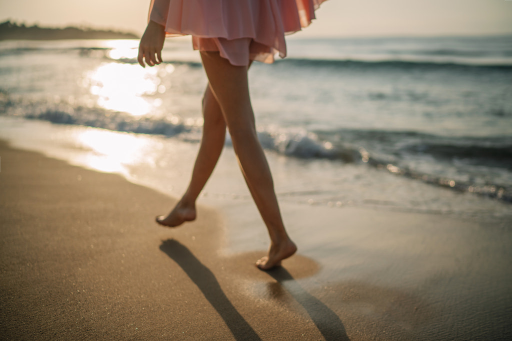 Young woman walking on the beach by Olha Dobosh on 500px.com