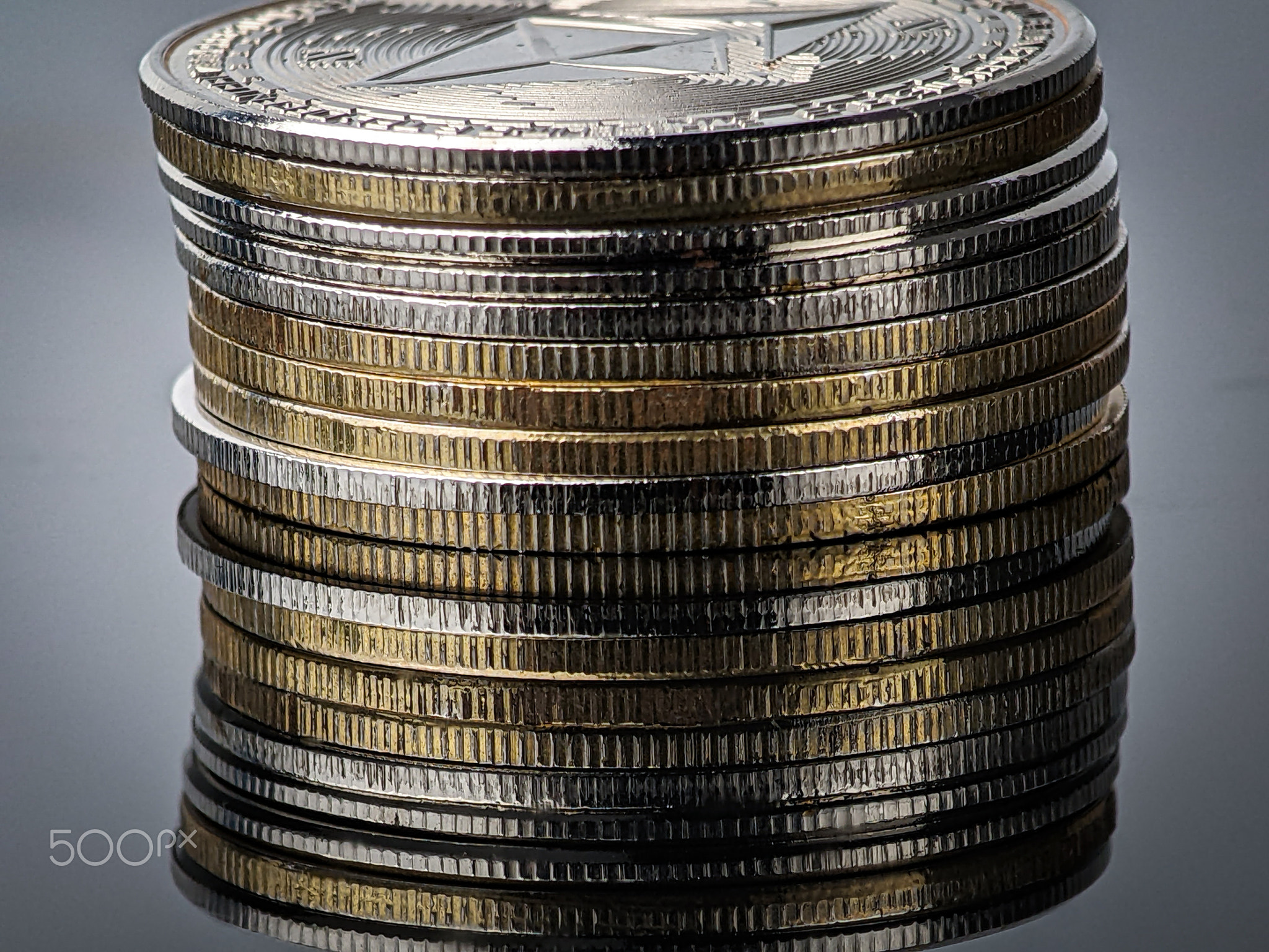 Closeup silver ethereum and gold Bitcoin with reflection on black acrylic board, Closeup silver ethe