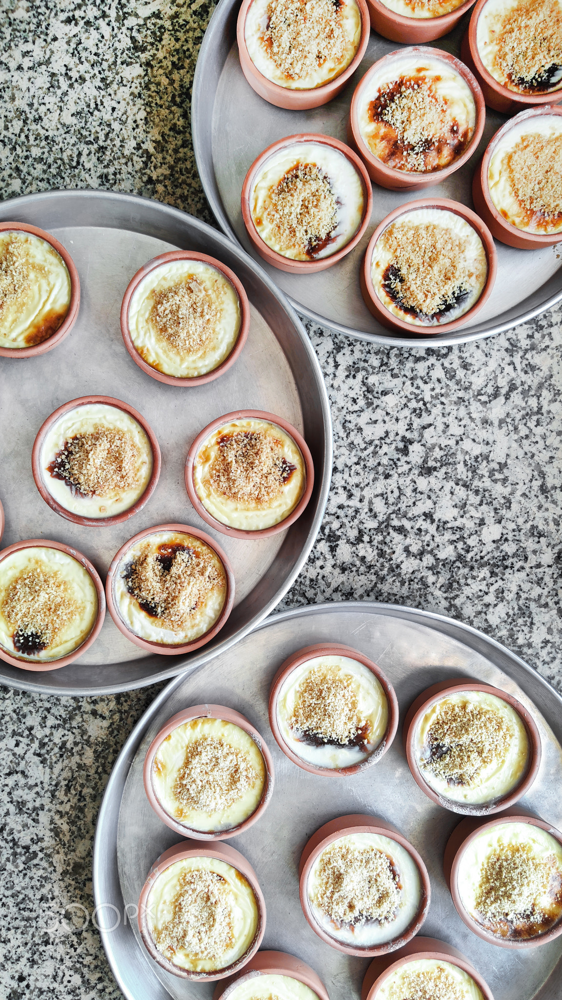 Plates with Turkish rice pudding Syutlach stand on round metal trays