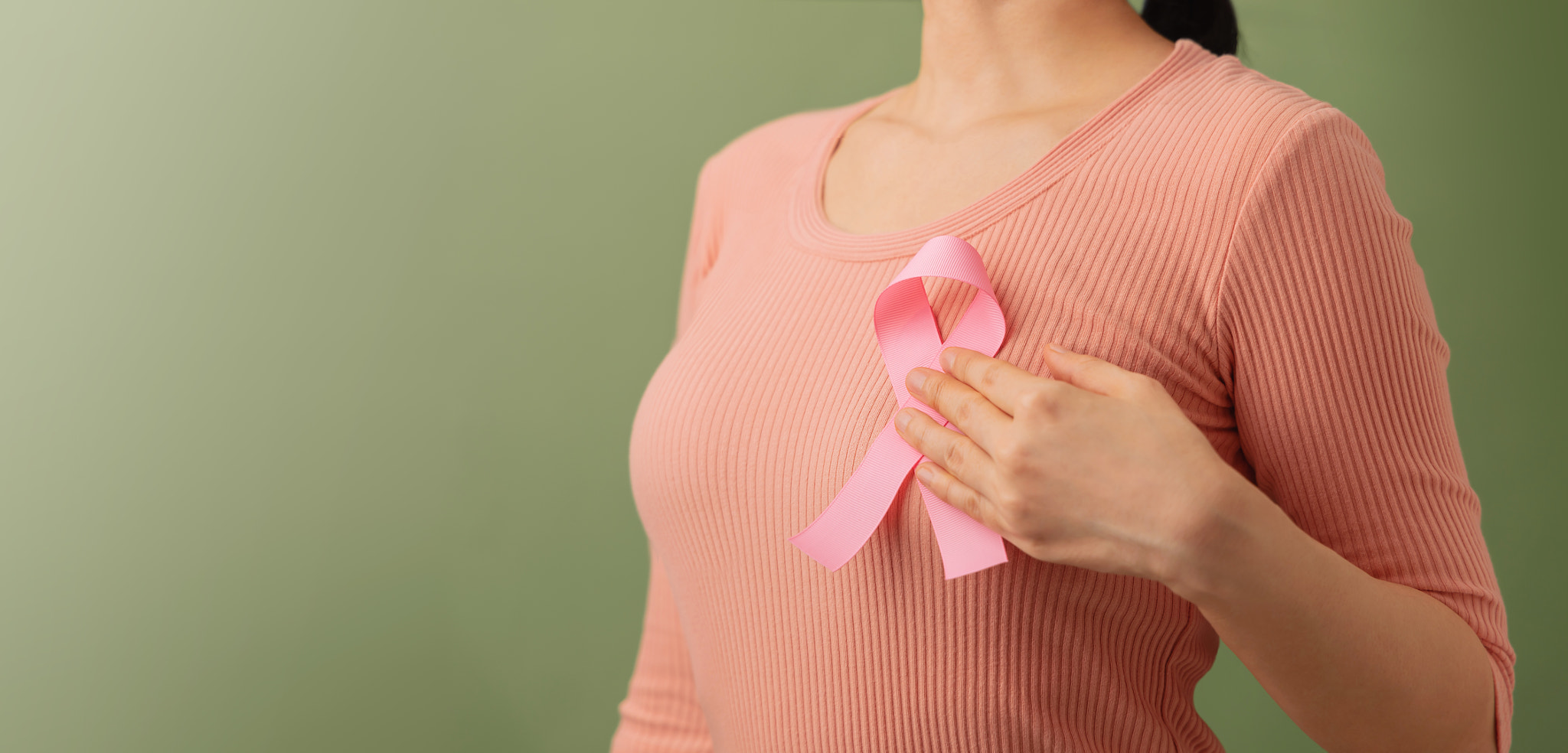 Breast Cancer Awareness Campaign Concept. Women Healthcare. Close up of a Young Female Touching Pink