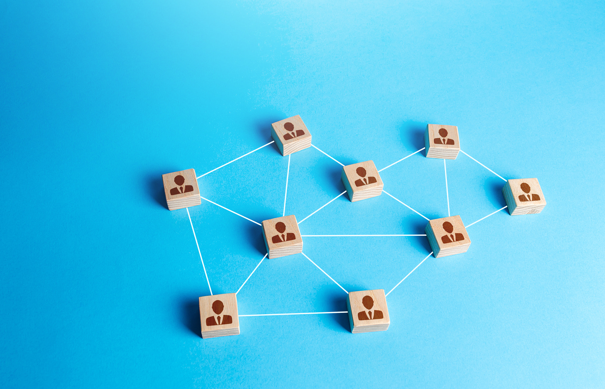 Network of connected staff blocks figurines by line. Unconventional company structure, distribution