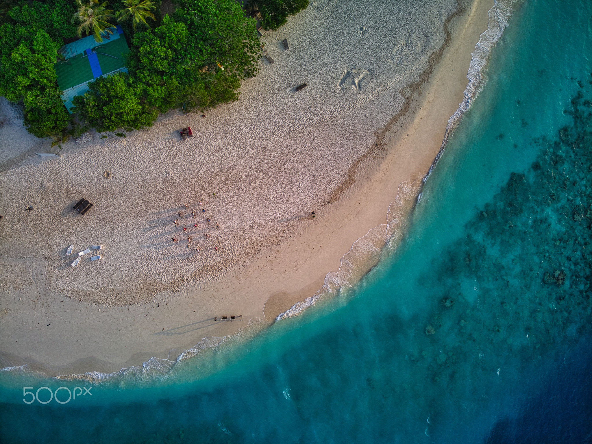 Tropical paradise with blue sea and green island in the maldives