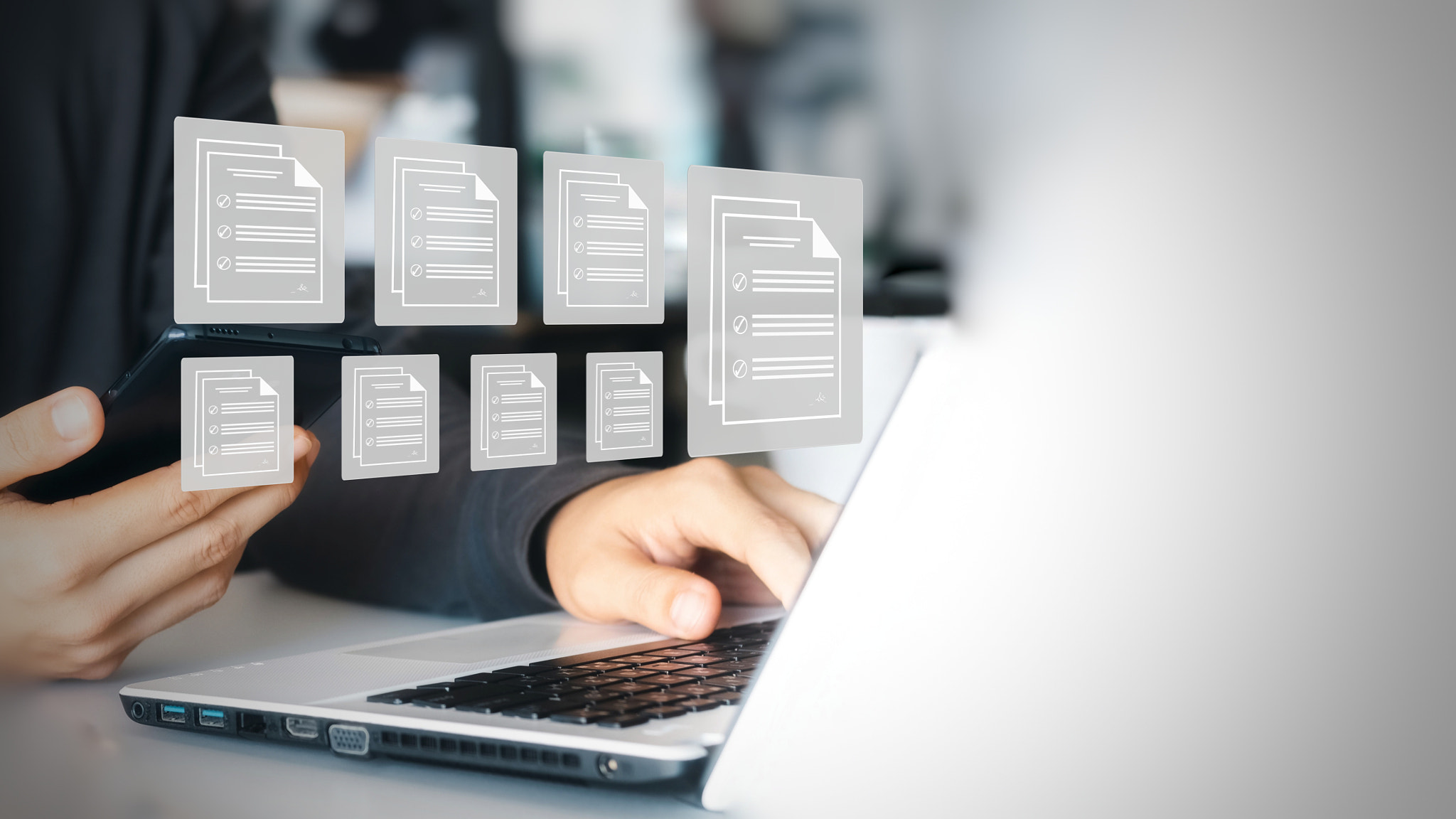 Cropped hands of woman using laptop on table