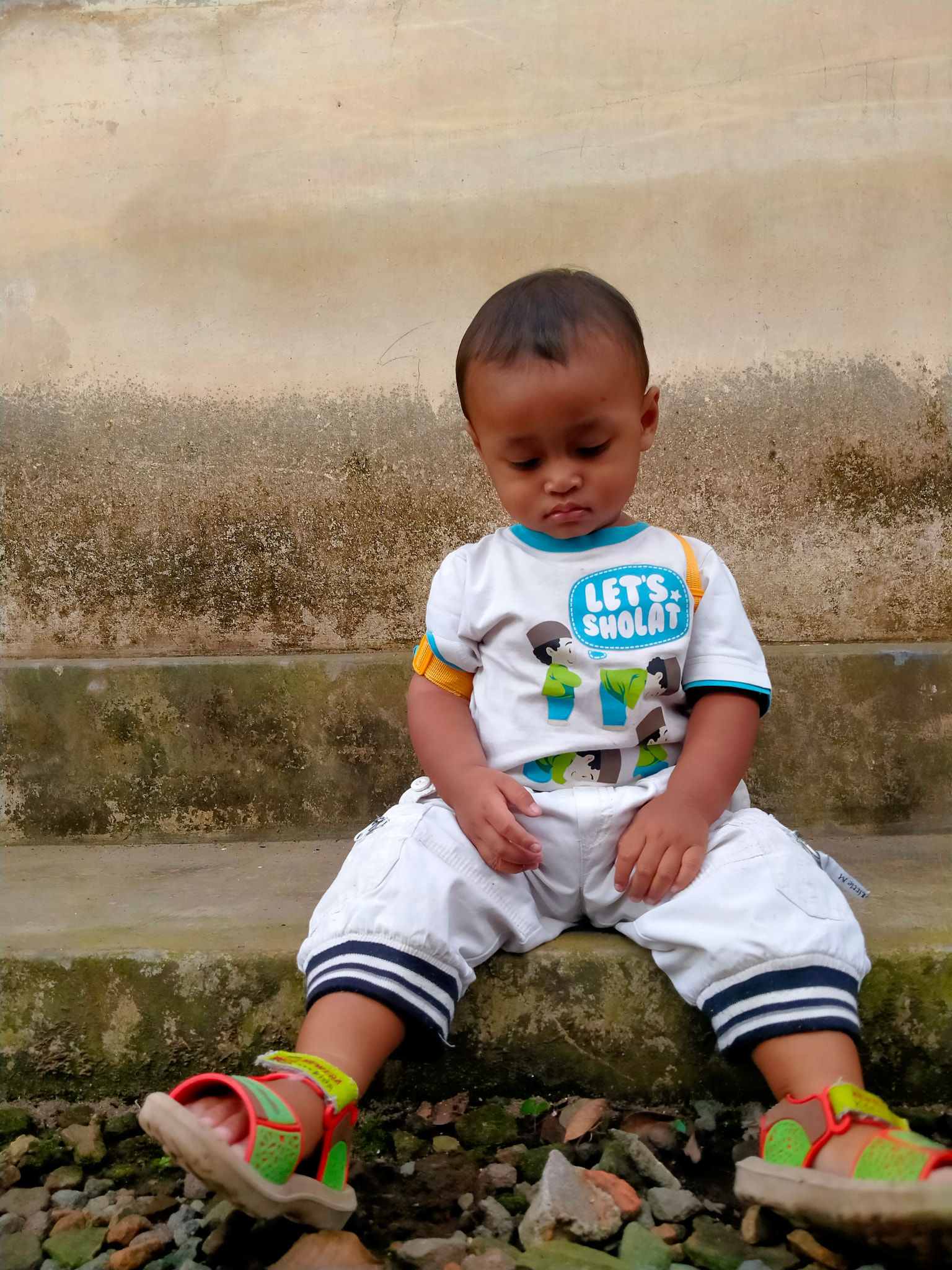 a child tries to pose in front of the camera in a natural style