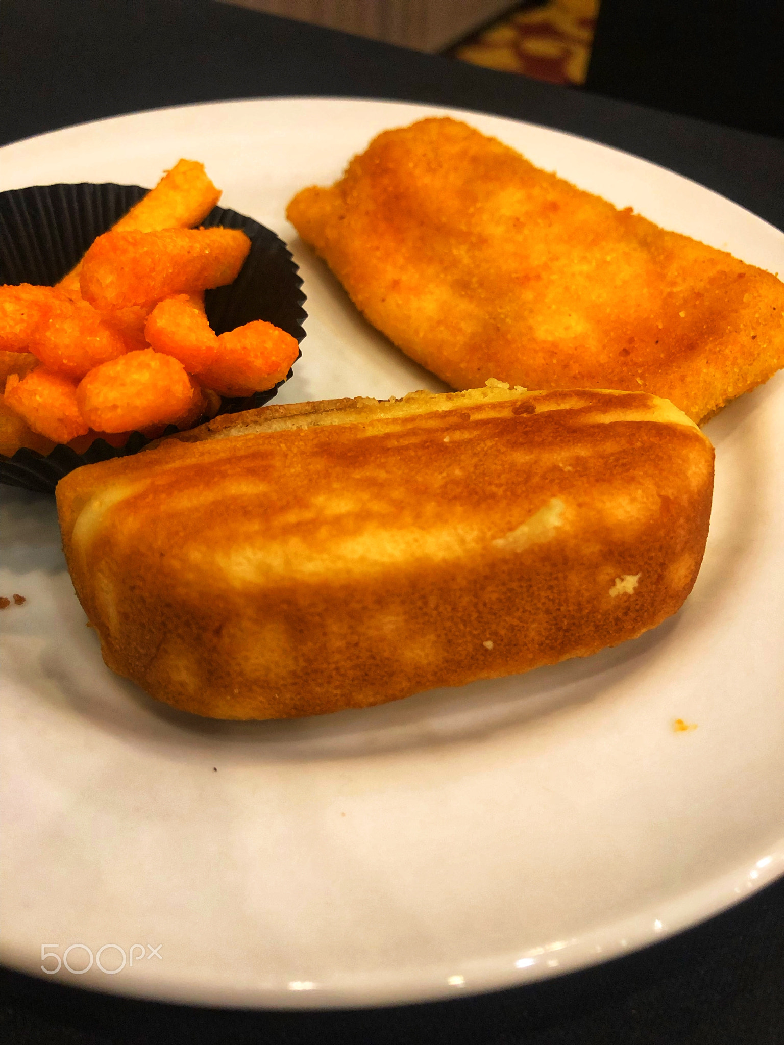 Coffee break with pancong cake, risol and ciki on a white plate