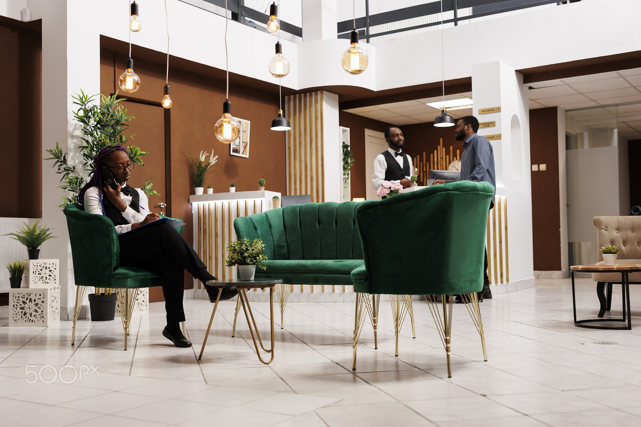 Hotel manager talking phone in lobby