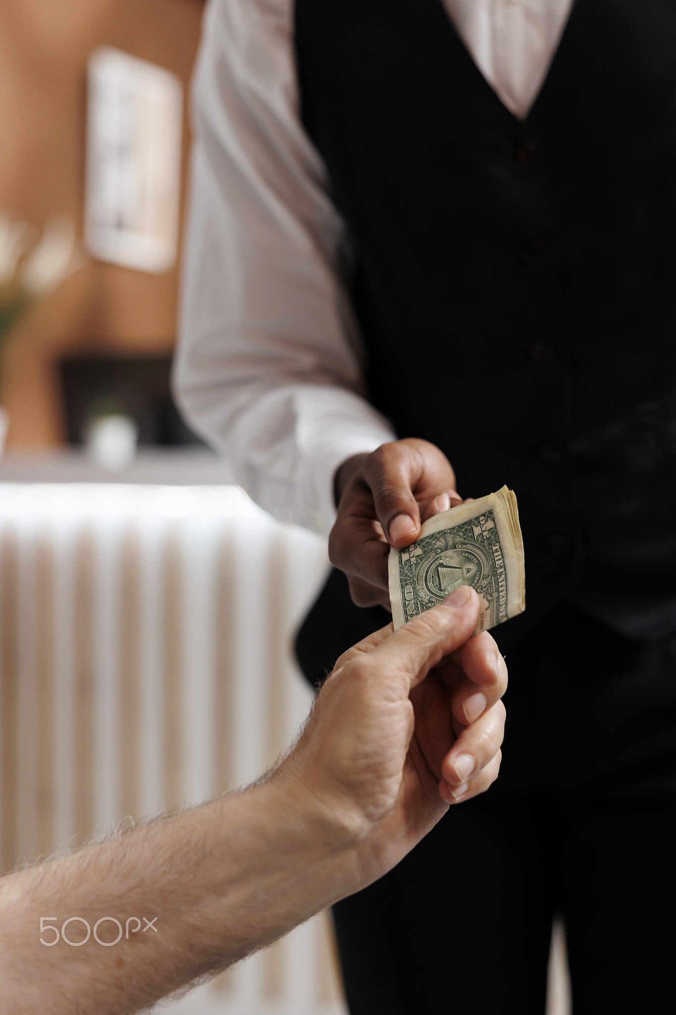 Bellhop receiving cash tip from customer