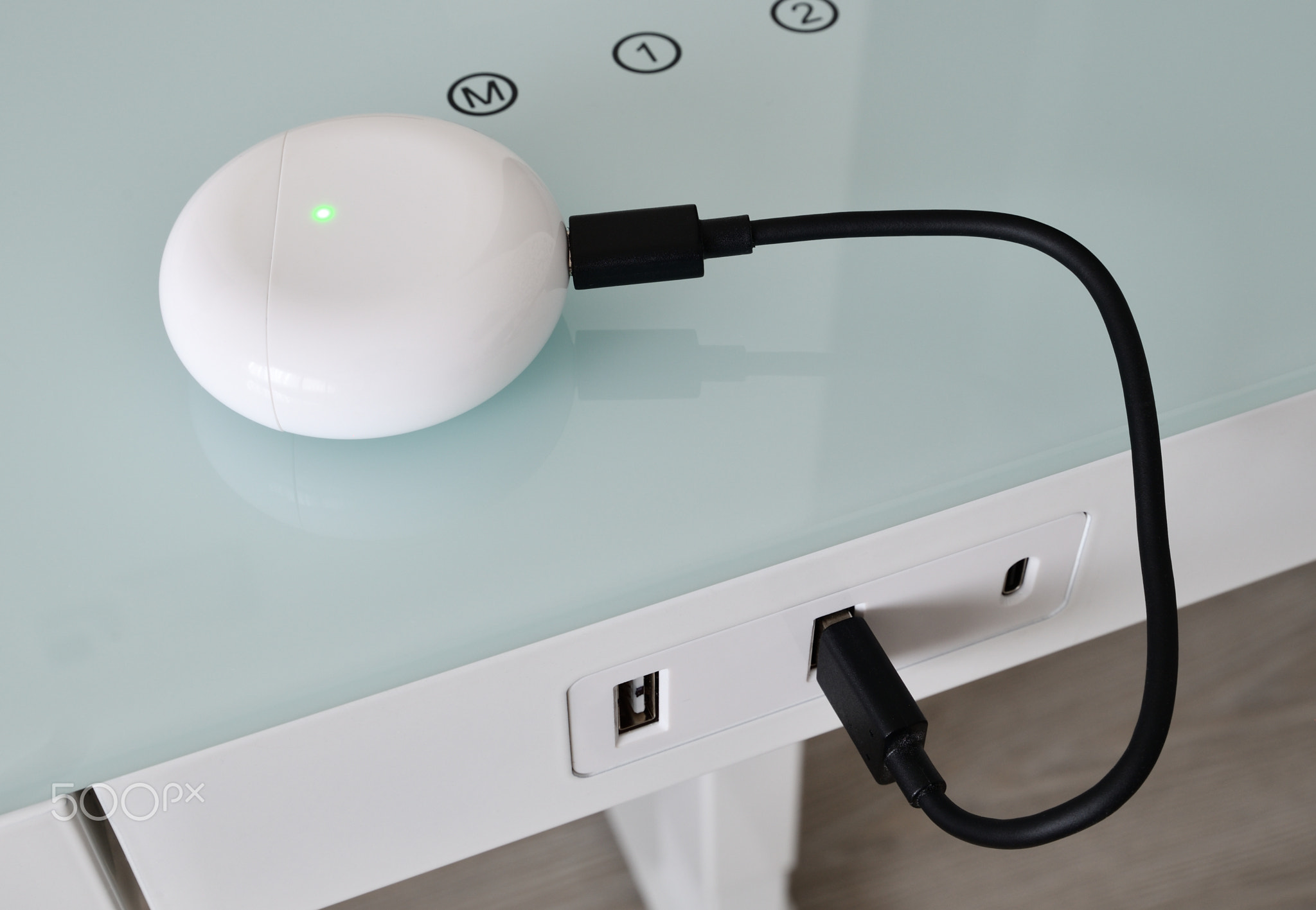 Box for wireless headphones is charged from the USB table