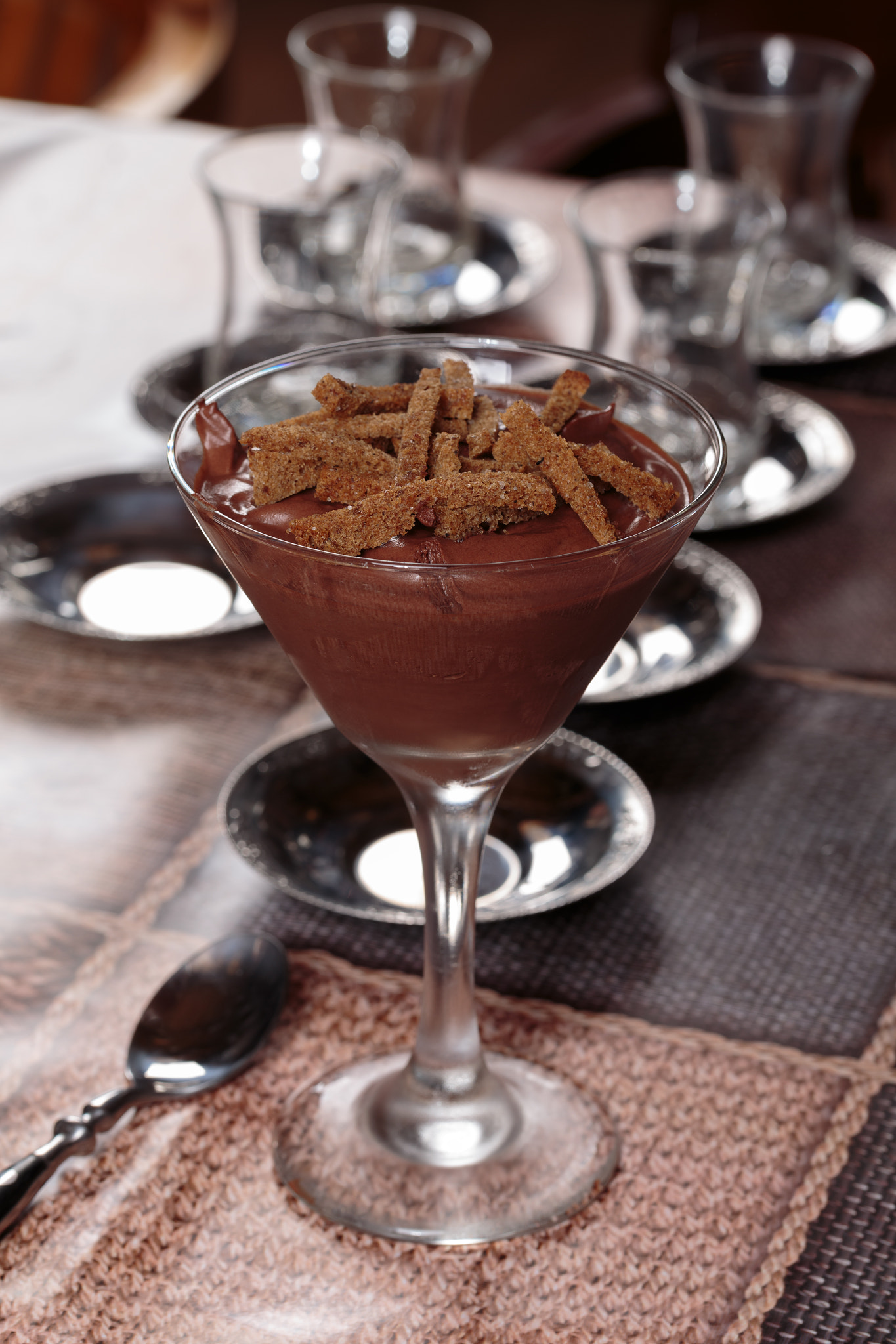 Chocolate mousse dessert with rusks in glasses.